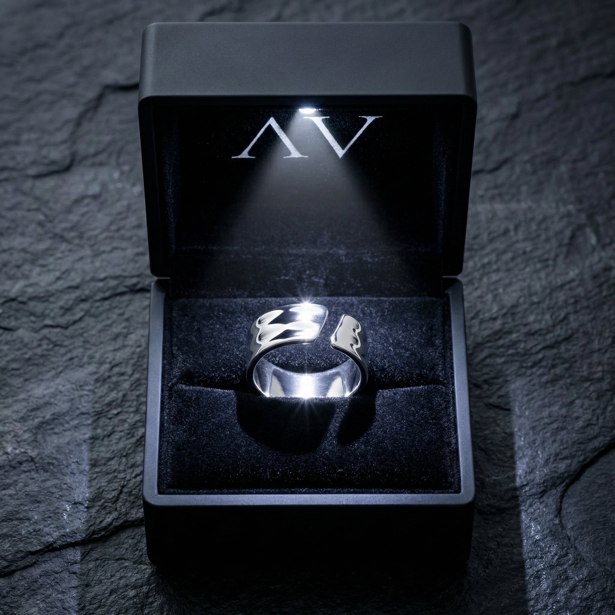 Silver stainless steel Origin Flex adjustable ring inside a lighted black jewelry presentation box.