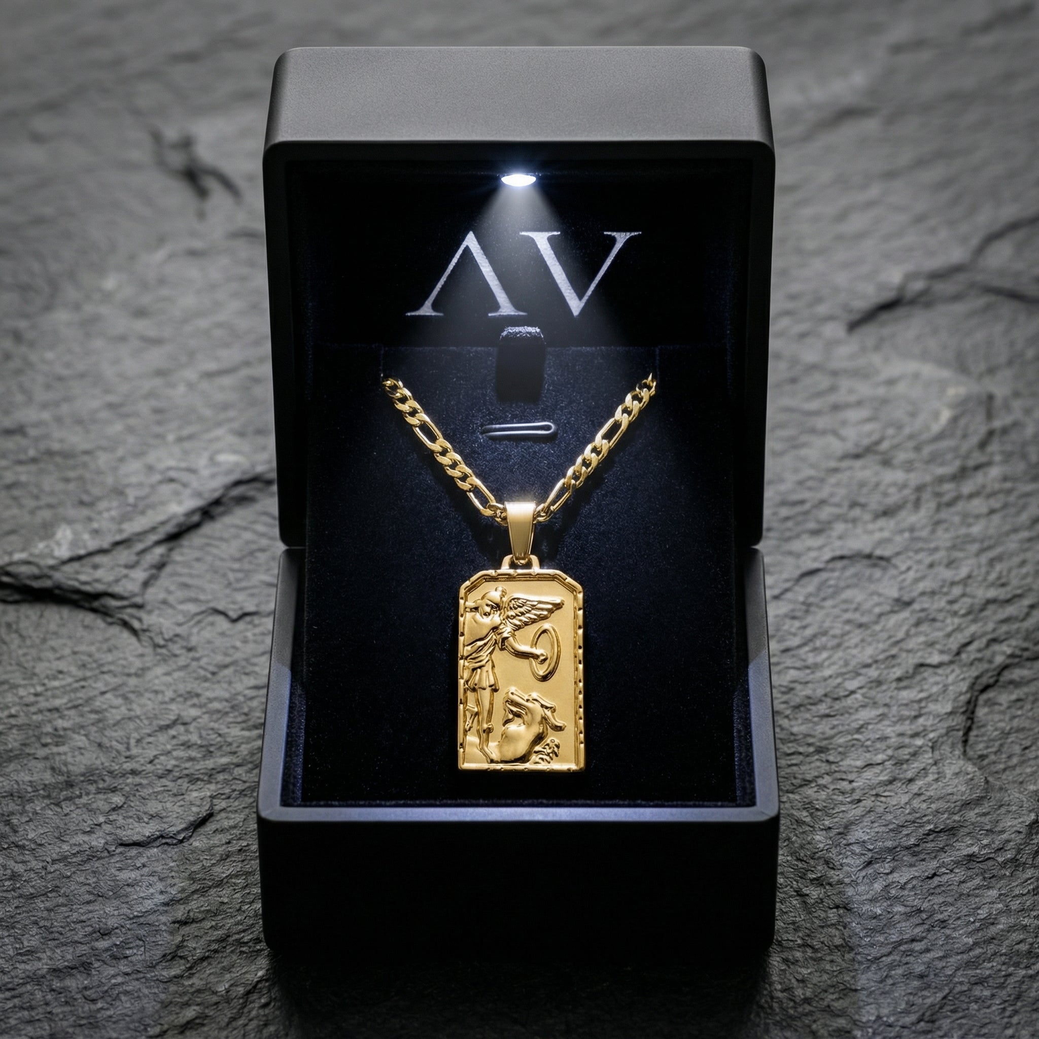 Gold stainless steel St. Michael Archangel pendant necklace displayed inside a black LED-lit branded jewelry box.