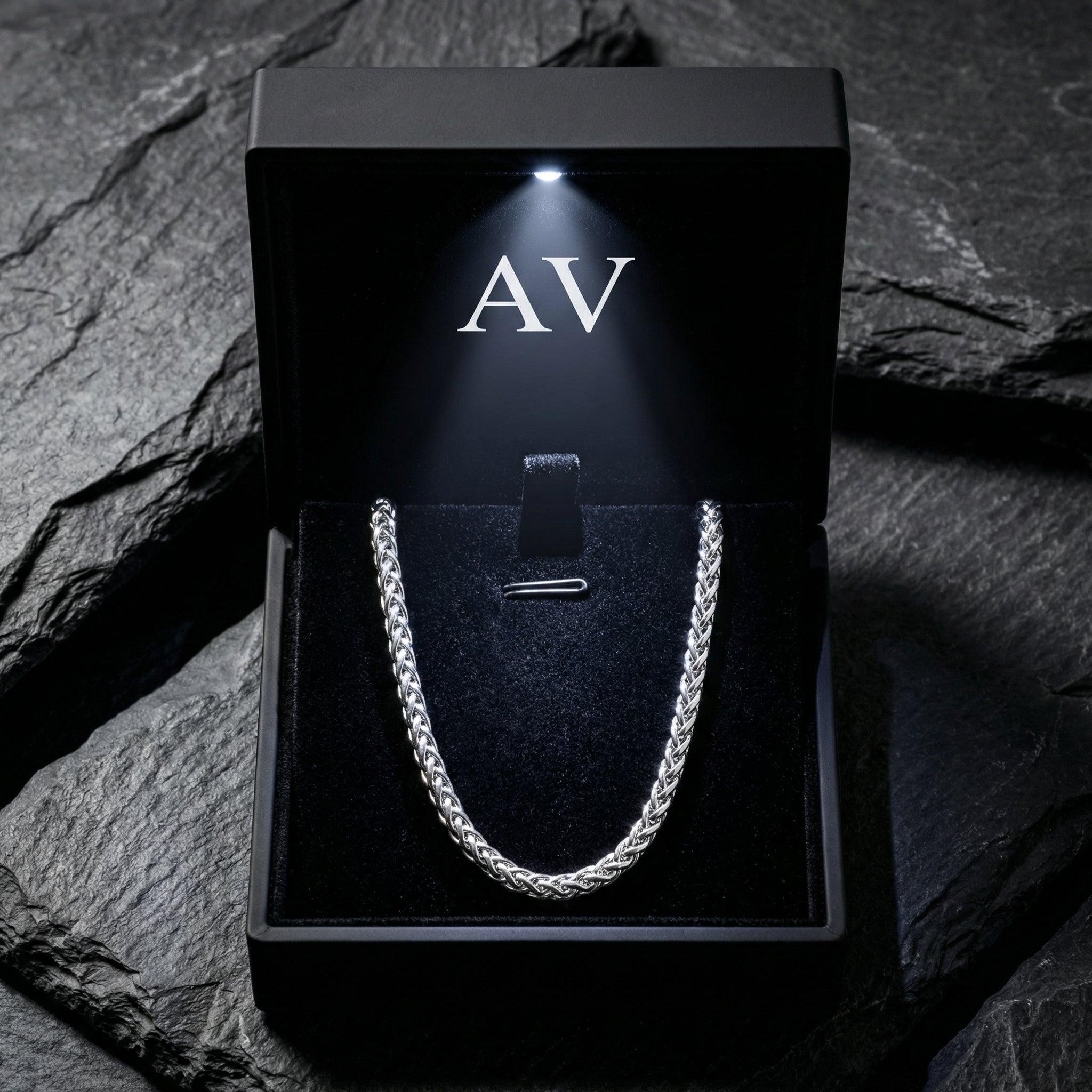 Silver stainless steel wheat weave chain inside a premium black lighted jewelry gift box.