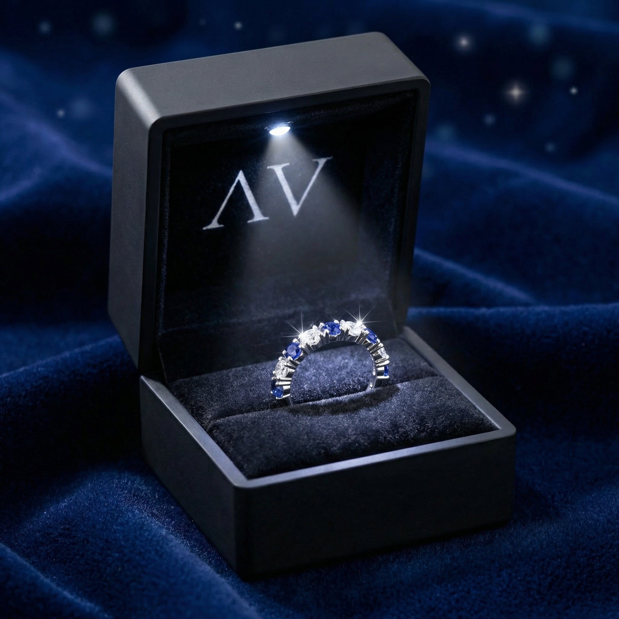 Thalissara sterling silver sapphire row ring presented in a black LED-lit velvet jewelry box.