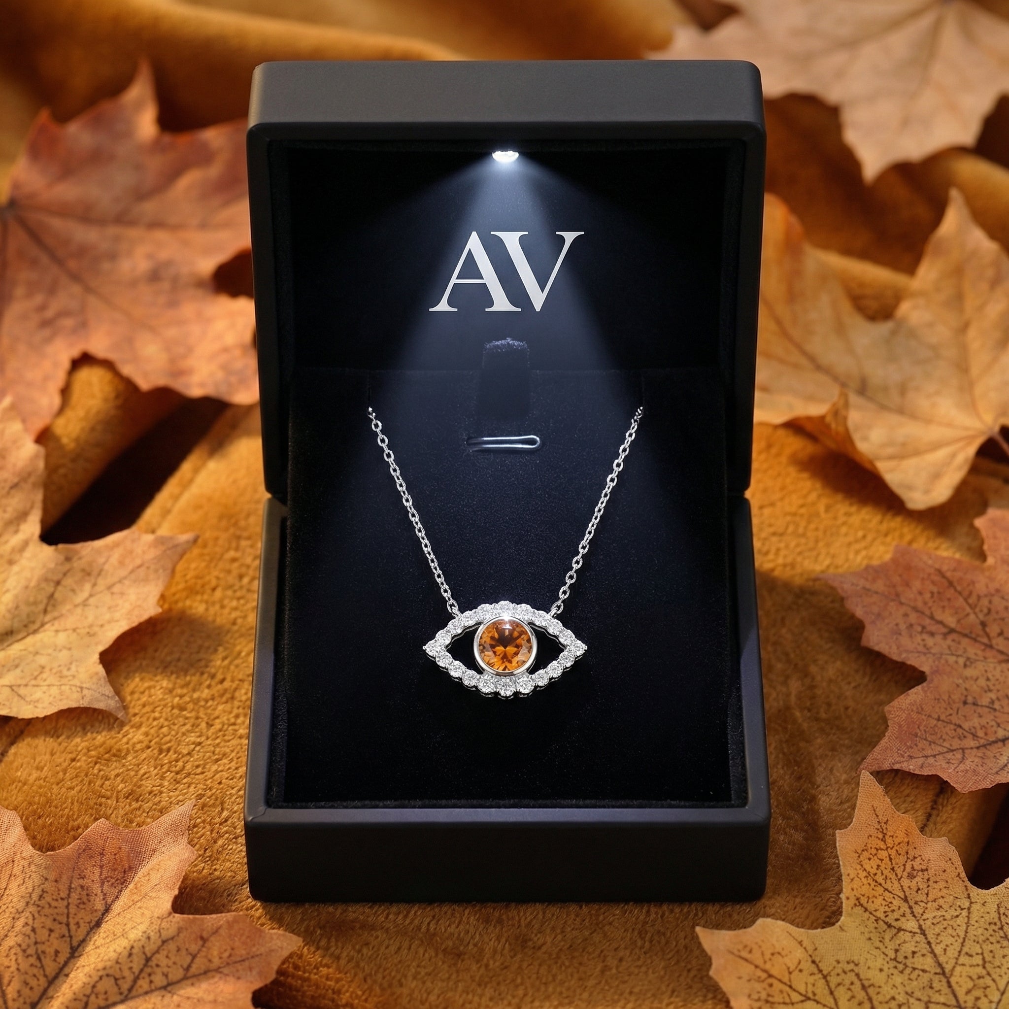 Sterling silver Hesperis Eye necklace with honey moissanite displayed in a black LED-lit jewelry gift box.