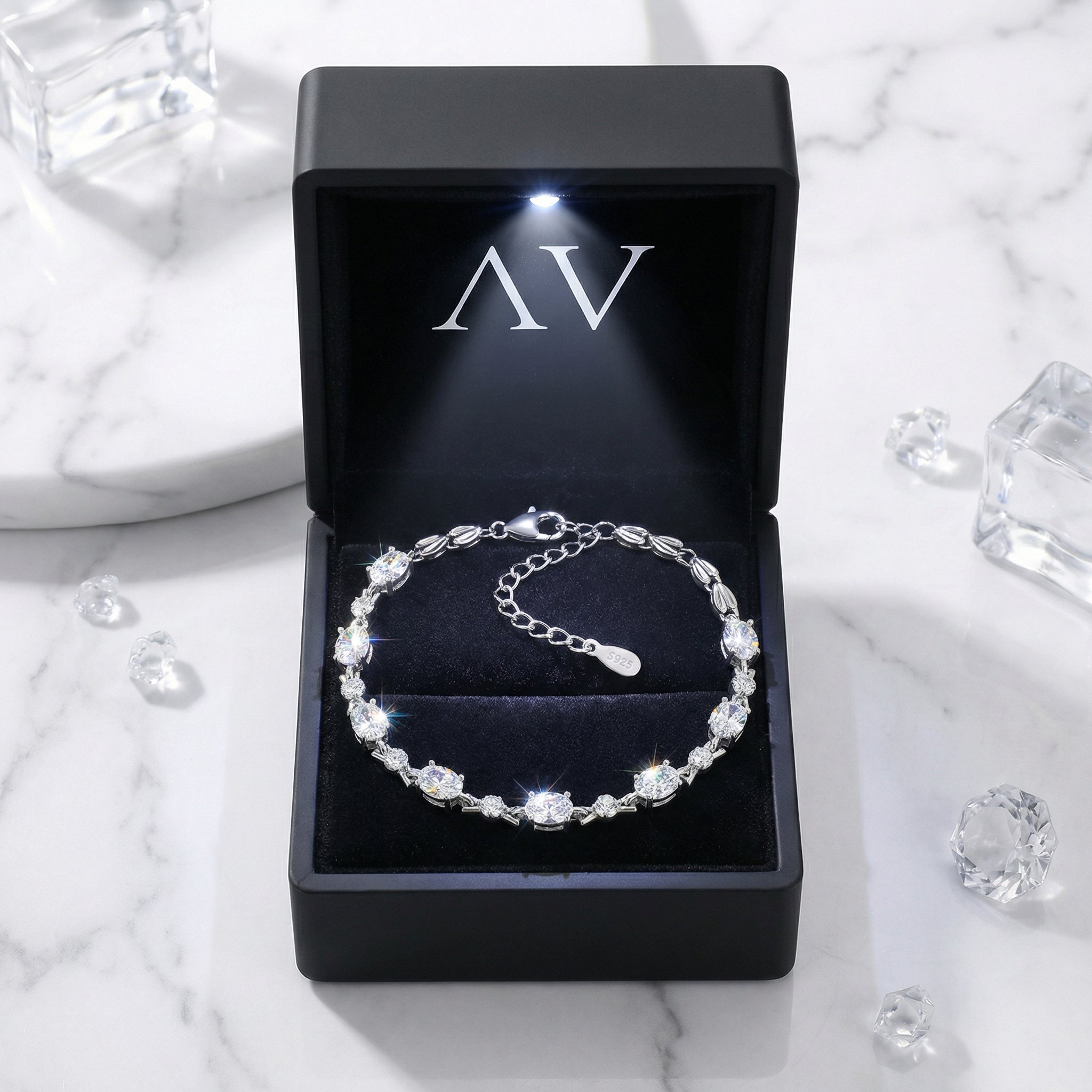Oval cut simulated diamond sterling silver bracelet inside a premium black LED-lit jewelry gift box.