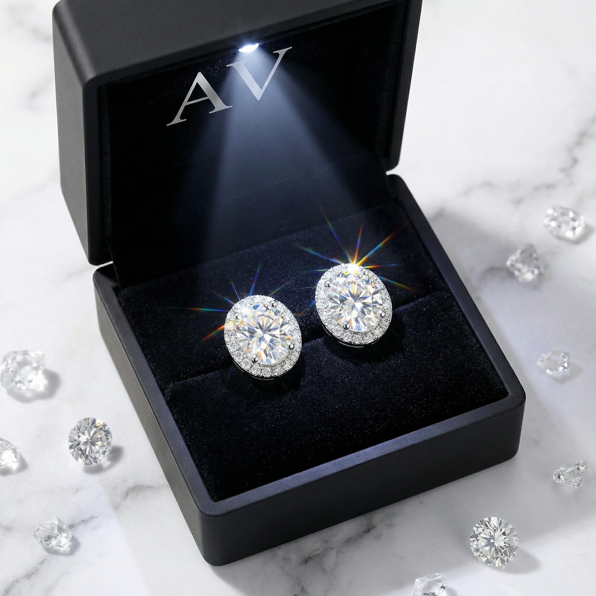 Sterling silver round cut zirconia halo stud earrings presented in a lighted black jewelry gift box.