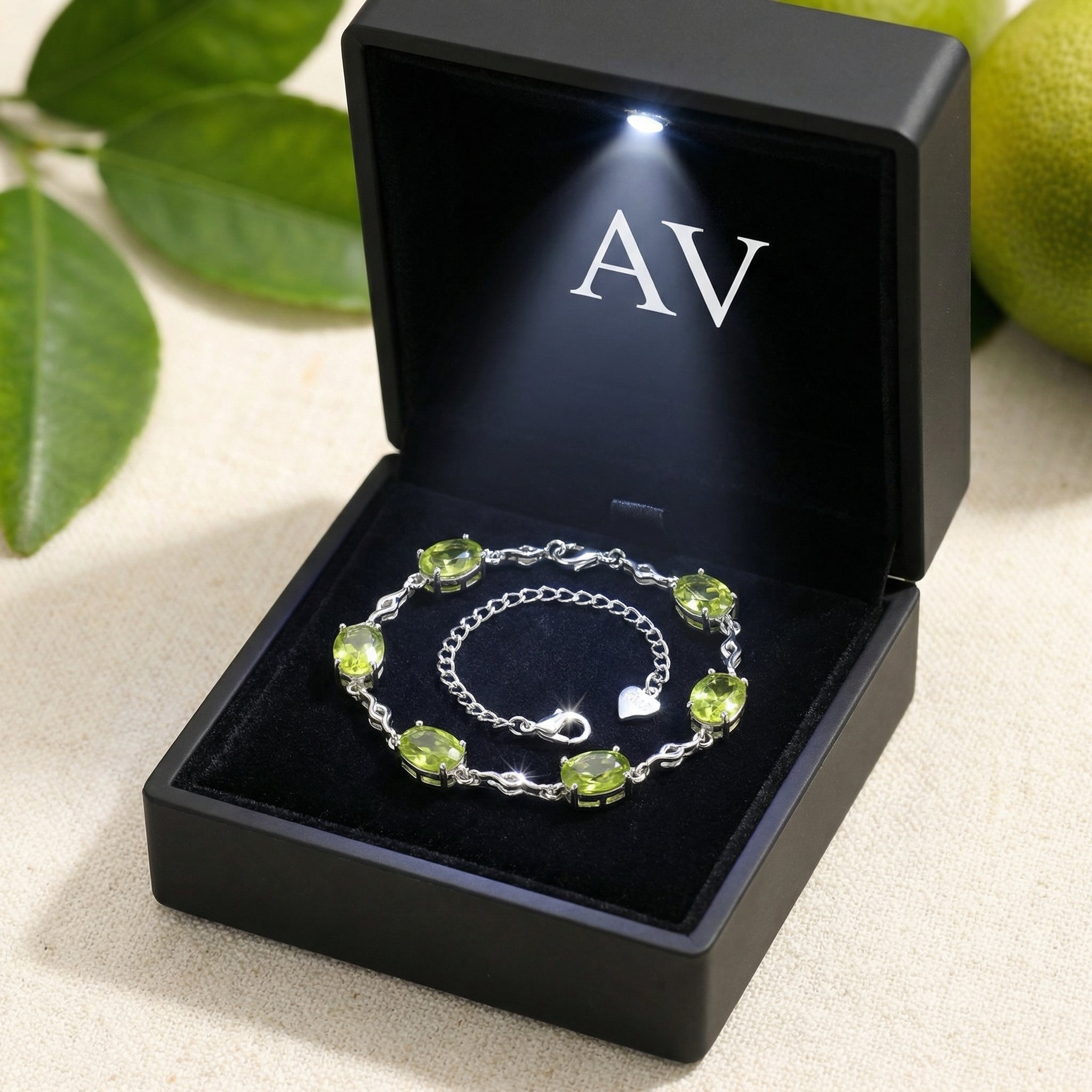 Sterling silver simulated peridot station bracelet in a black luxury gift box with an integrated LED light.
