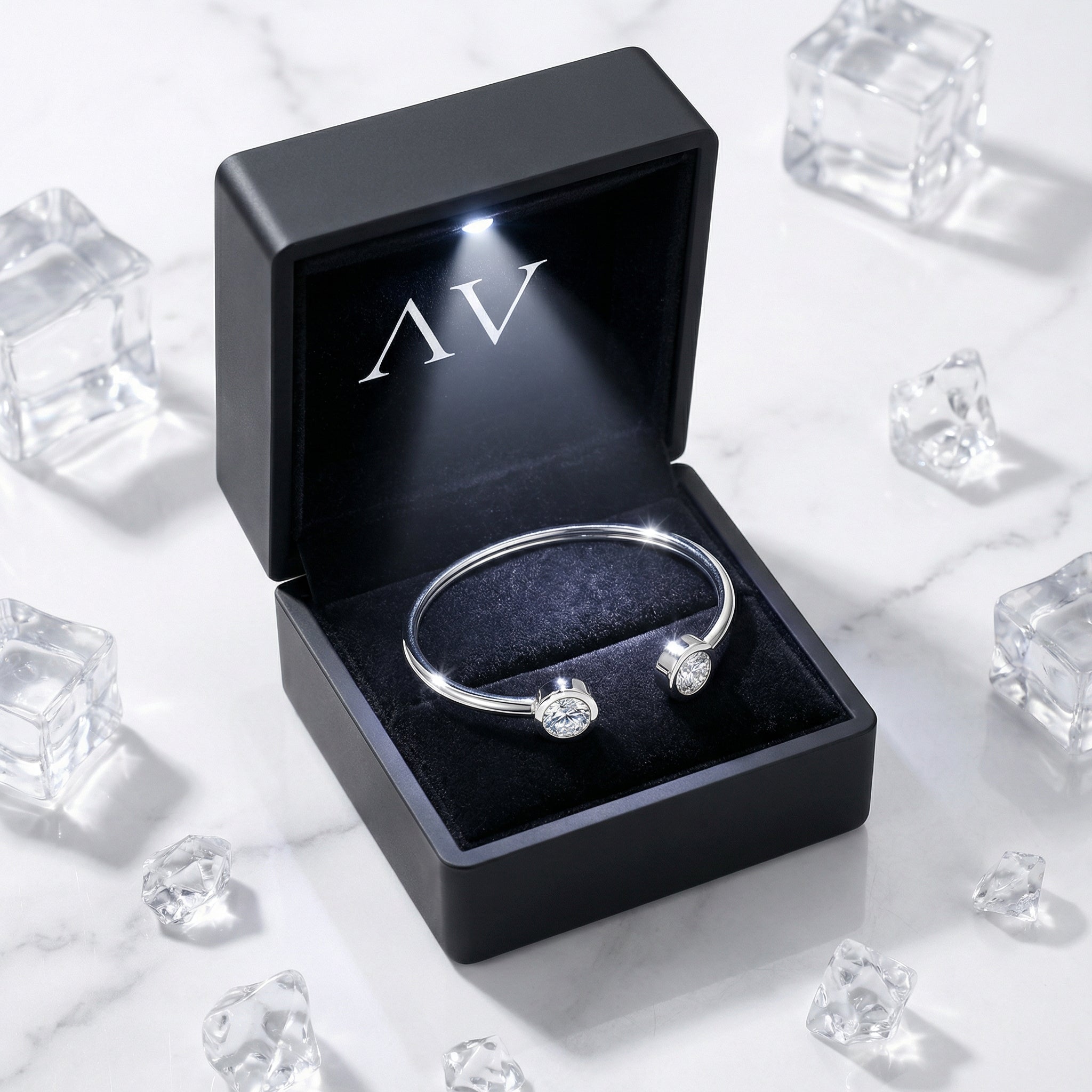 Silver stainless steel cuff bracelet with simulated diamonds inside a black LED-lighted jewelry gift box.