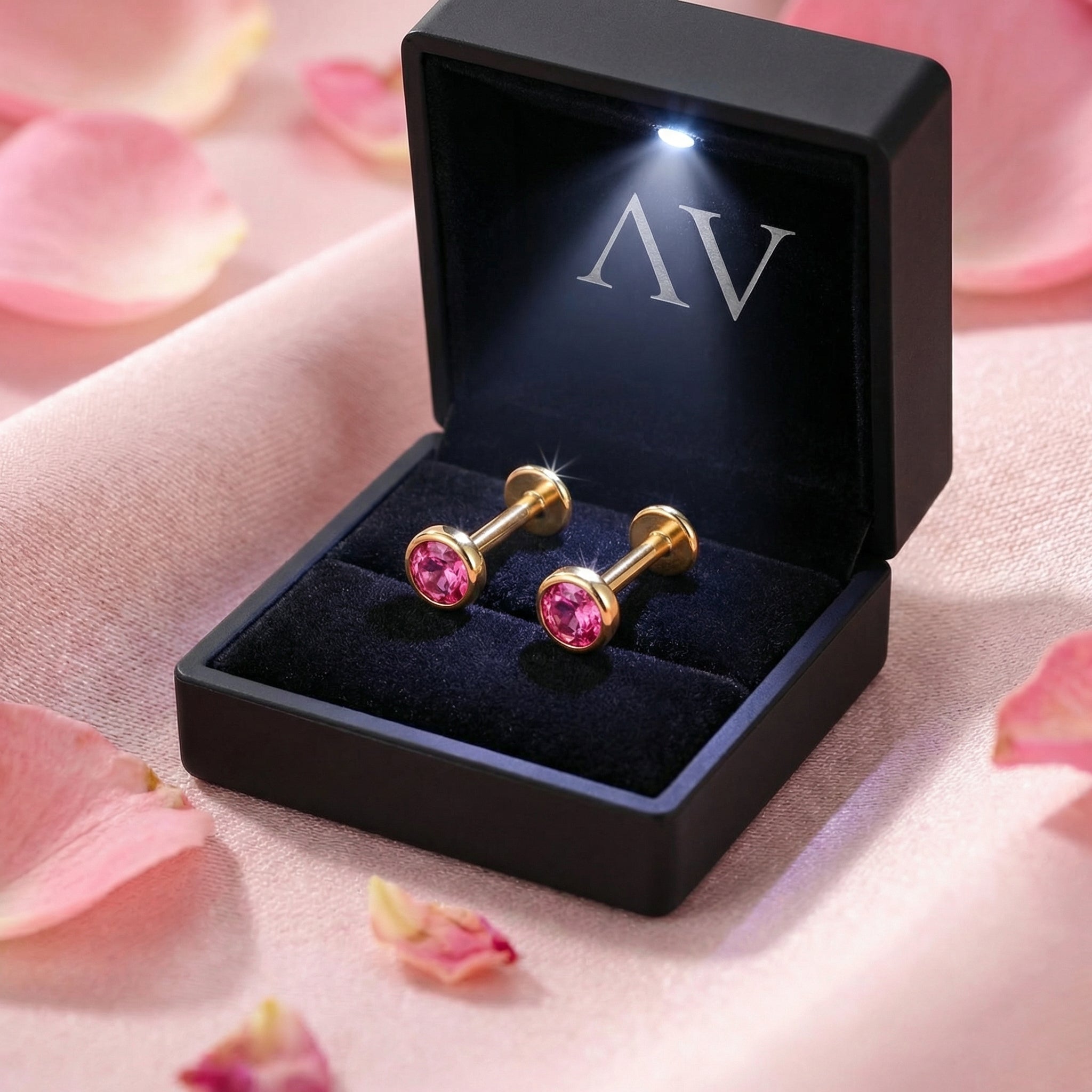 Marisel pink tourmaline bezel studs in 18K gold vermeil displayed in a black lighted jewelry gift box.