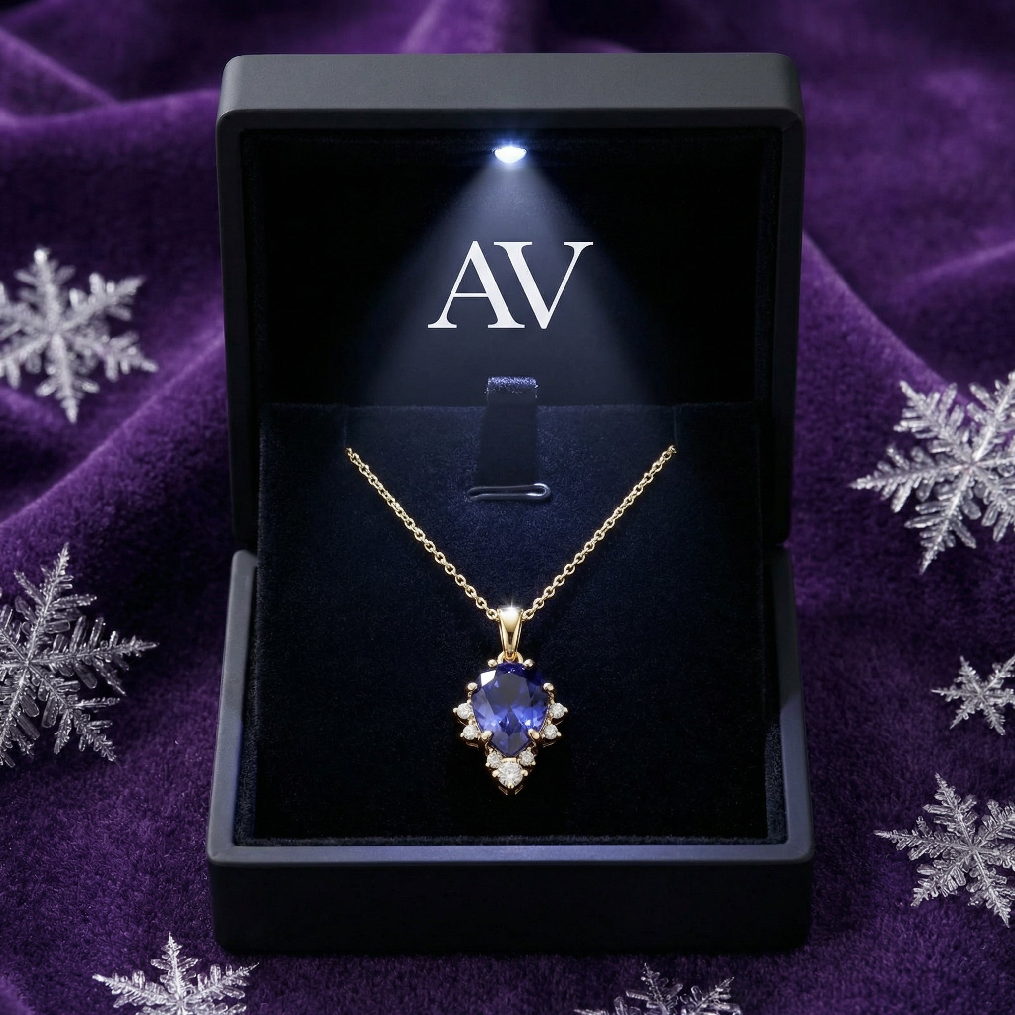 Pear-cut simulated tanzanite necklace in 18K gold vermeil inside a lighted black AV branded jewelry box.