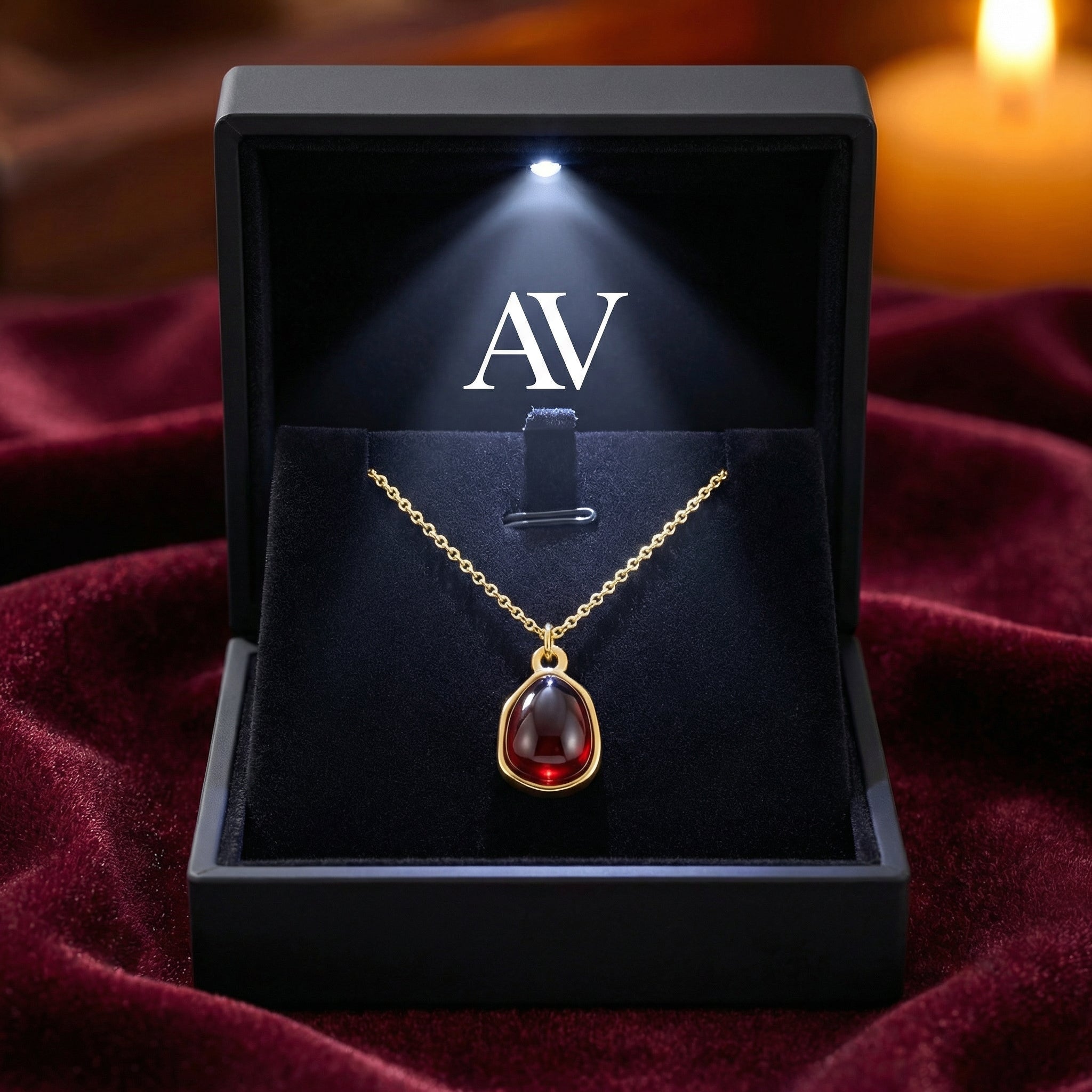 Teardrop simulated garnet necklace in a luxury black LED-lit gift box with AV branding.