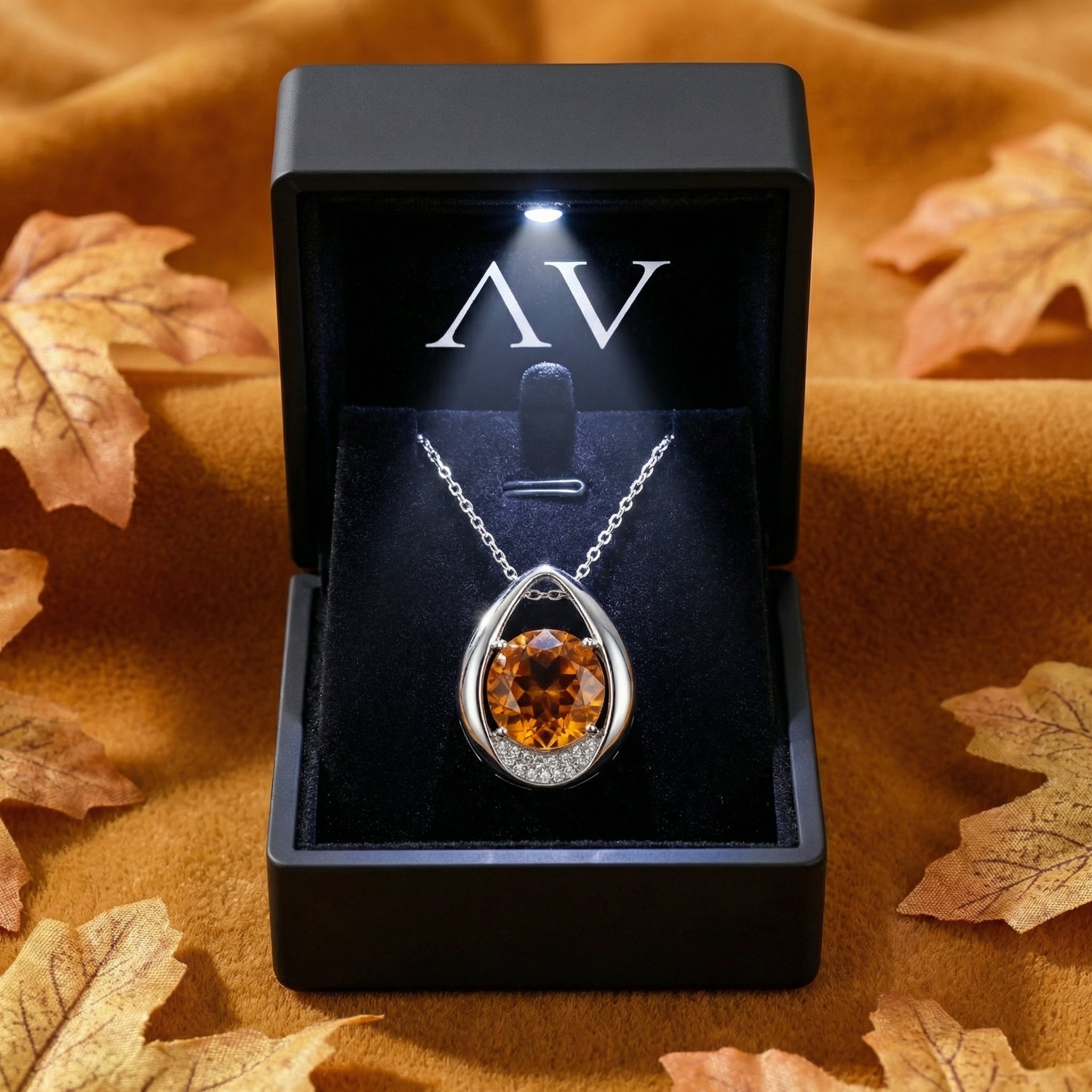 Aurellia teardrop necklace in S925 sterling silver with honey topaz inside a lighted black luxury gift box.