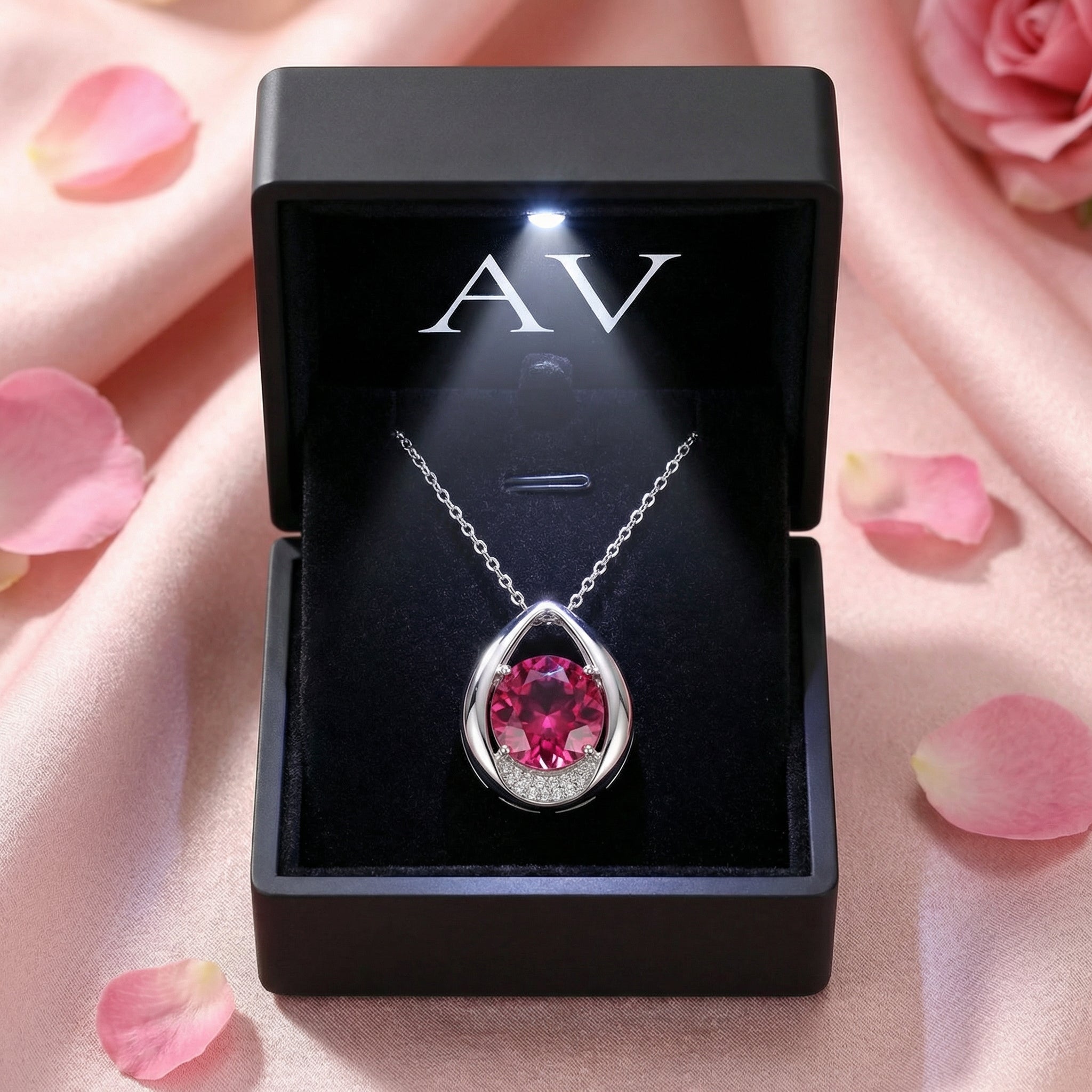Valisara teardrop necklace with simulated pink tourmaline in a premium black LED-lit jewelry presentation box.