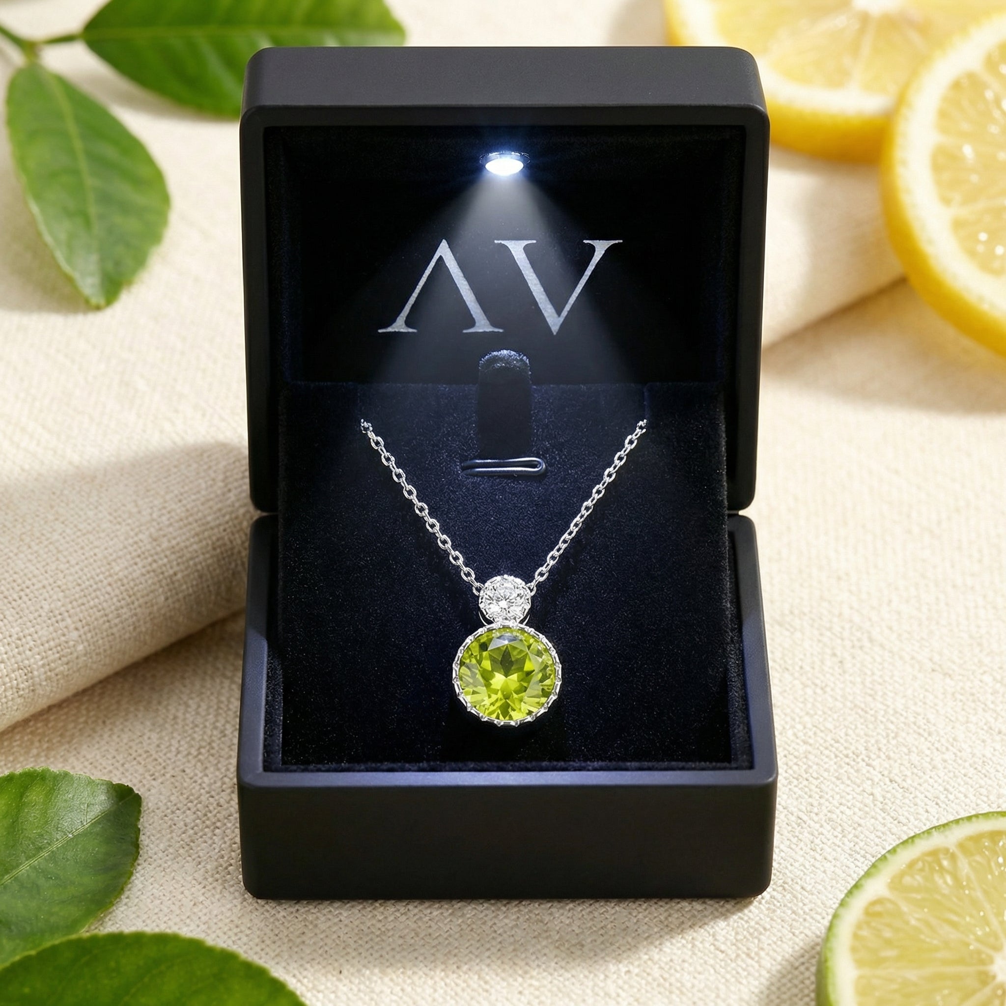 Round-cut simulated peridot silver necklace presented in a black lighted gift box for a luxury presentation.