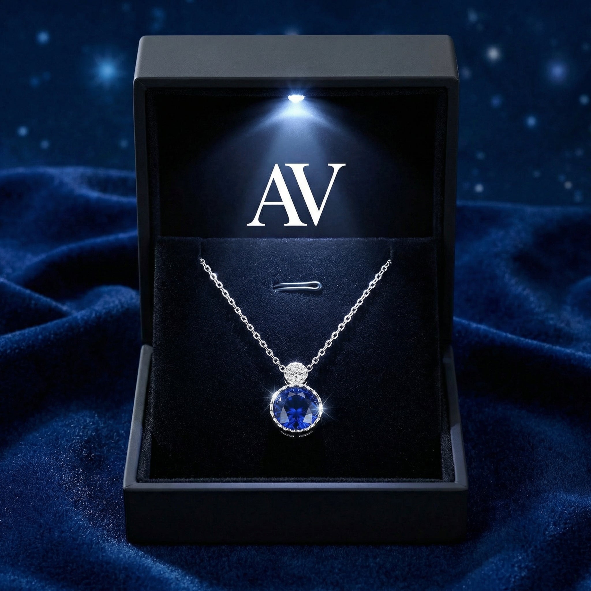 Sterling silver sapphire pendant presented in a black LED-lit gift box with the AV logo.