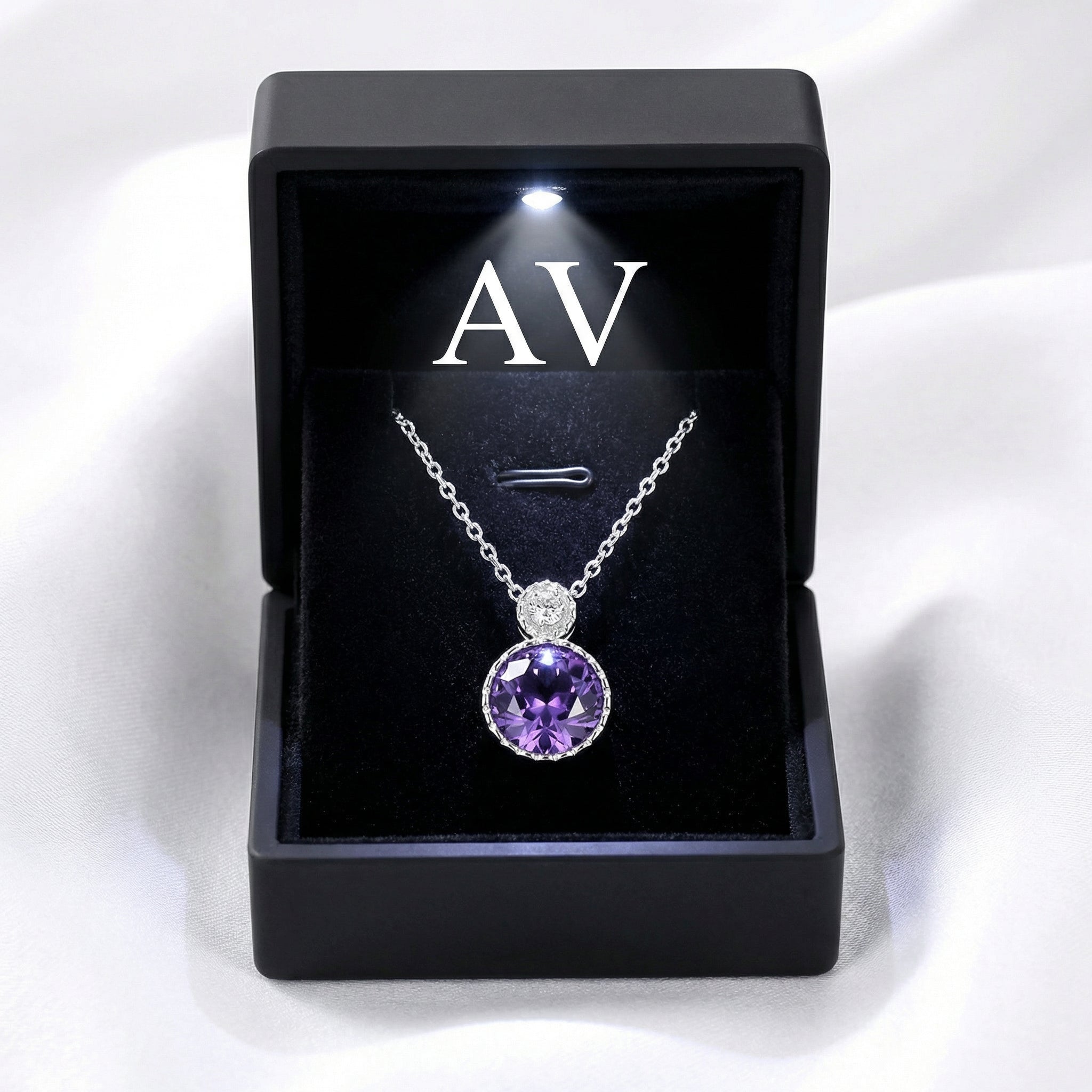 Round simulated amethyst sterling silver necklace presented in a black lighted gift box with AV branding.