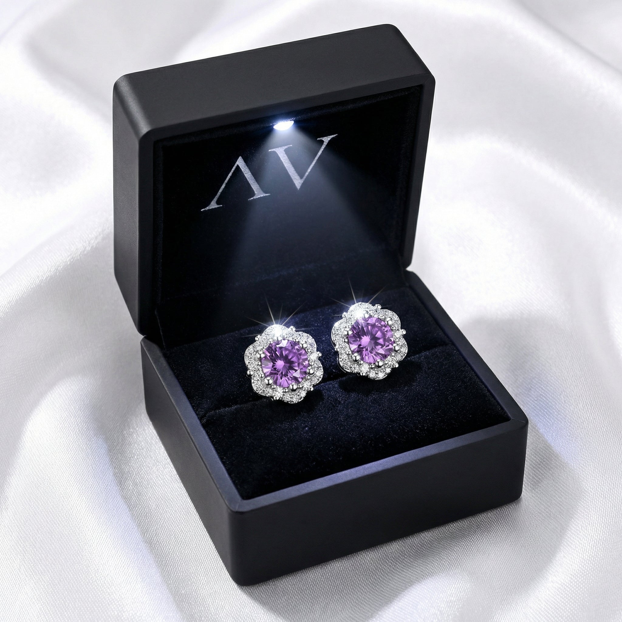 Round cut simulated amethyst halo stud earrings in S925 sterling silver inside a black LED-lit jewelry box.