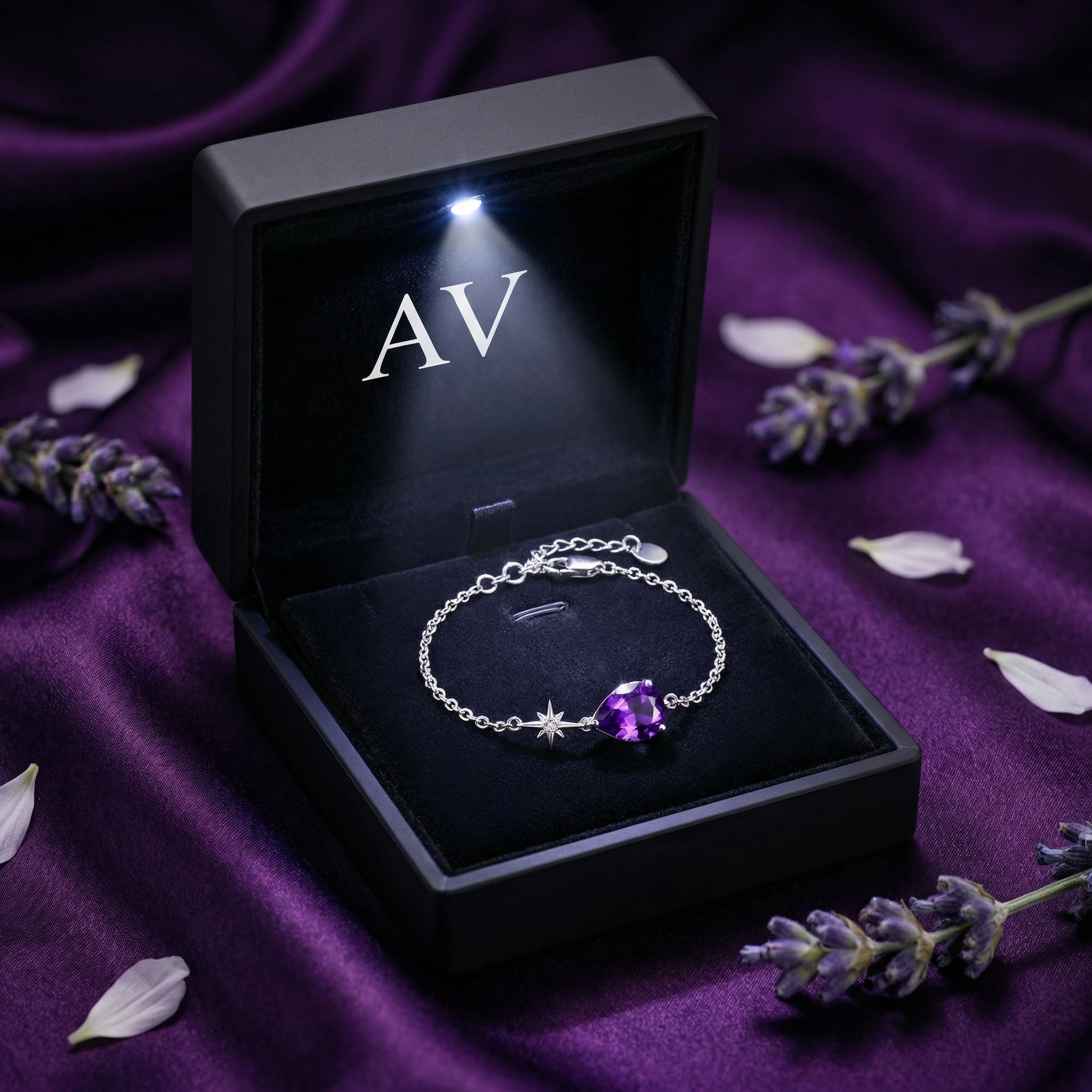 Pear cut amethyst sterling silver bracelet presented in a black LED-lit jewelry gift box.