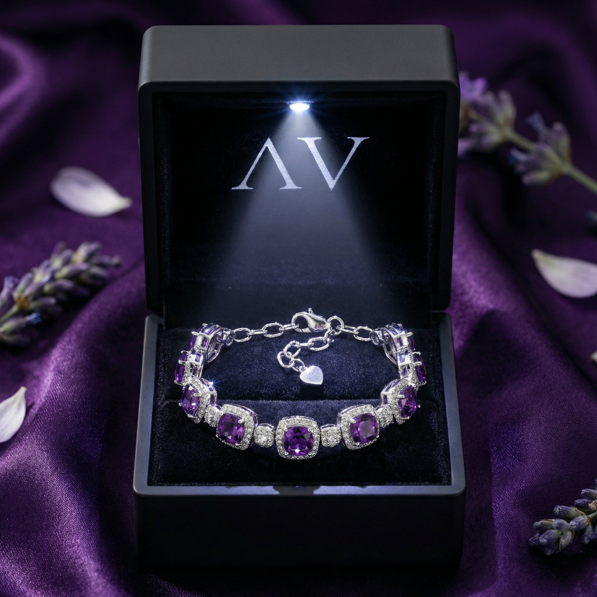 Cushion cut amethyst sterling silver bracelet presented in a lighted black jewelry gift box.
