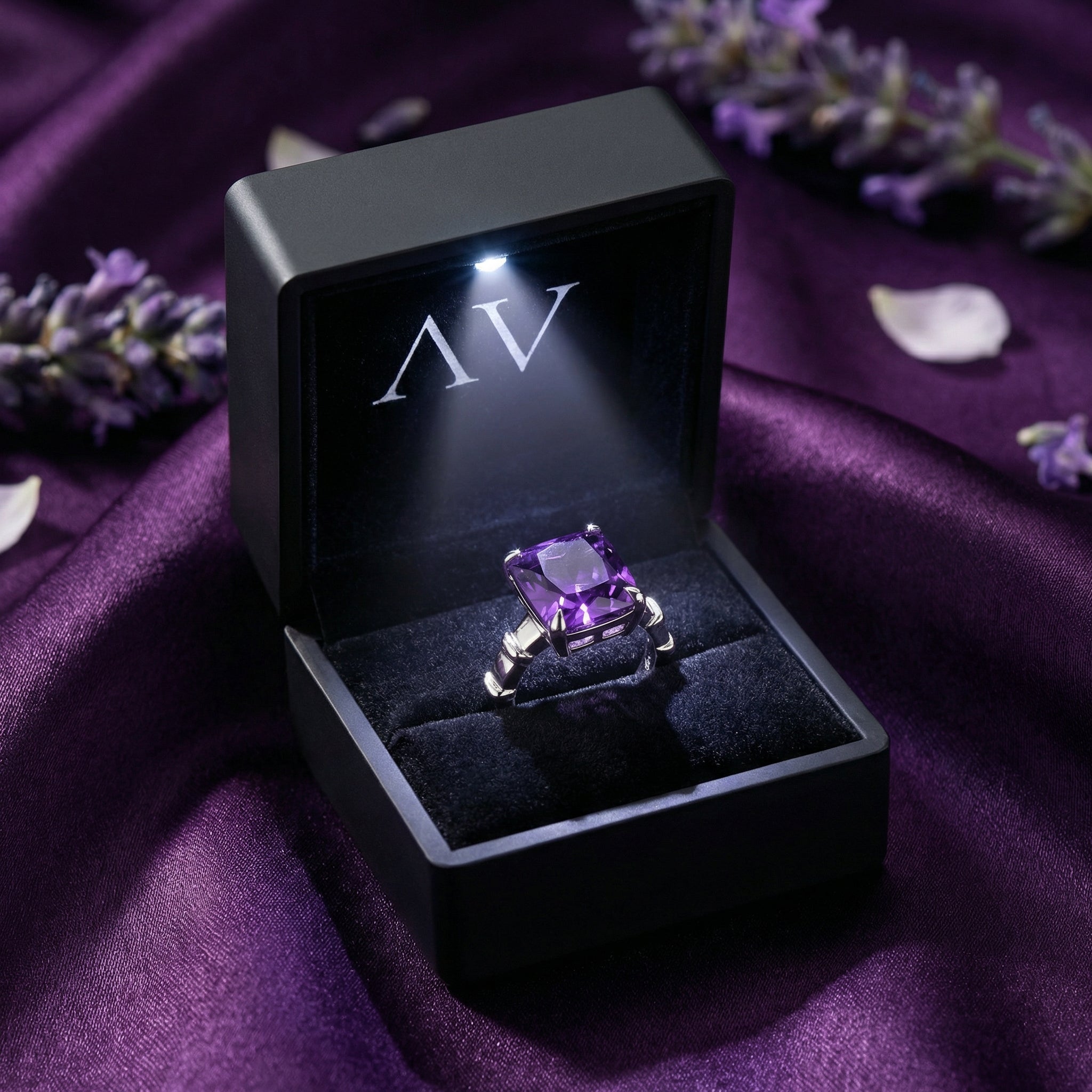 Square cut amethyst sterling silver ring presented in a black LED-lighted jewelry box.