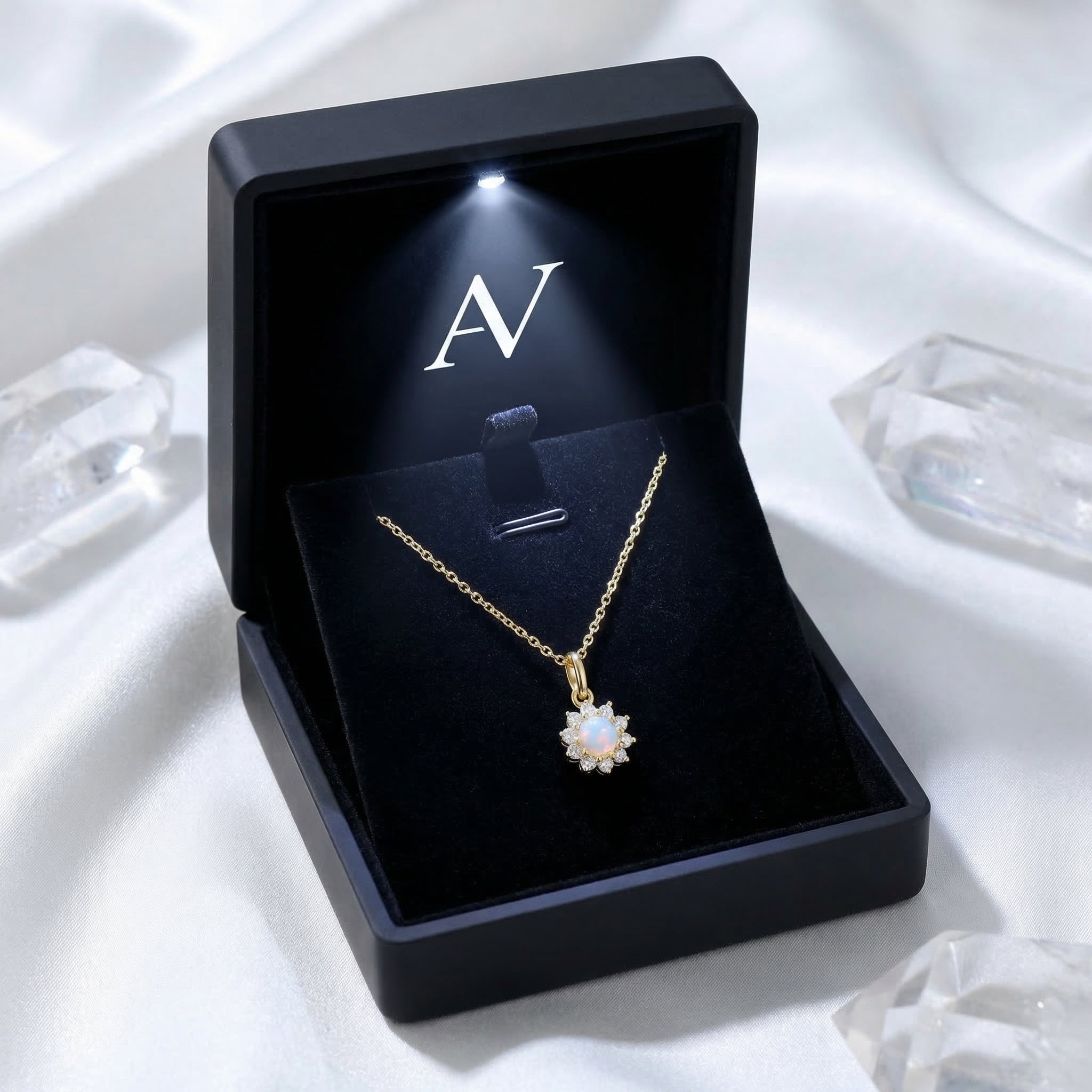 Gold-tone Celestria round white opal necklace displayed in a premium black lighted gift box on white silk.