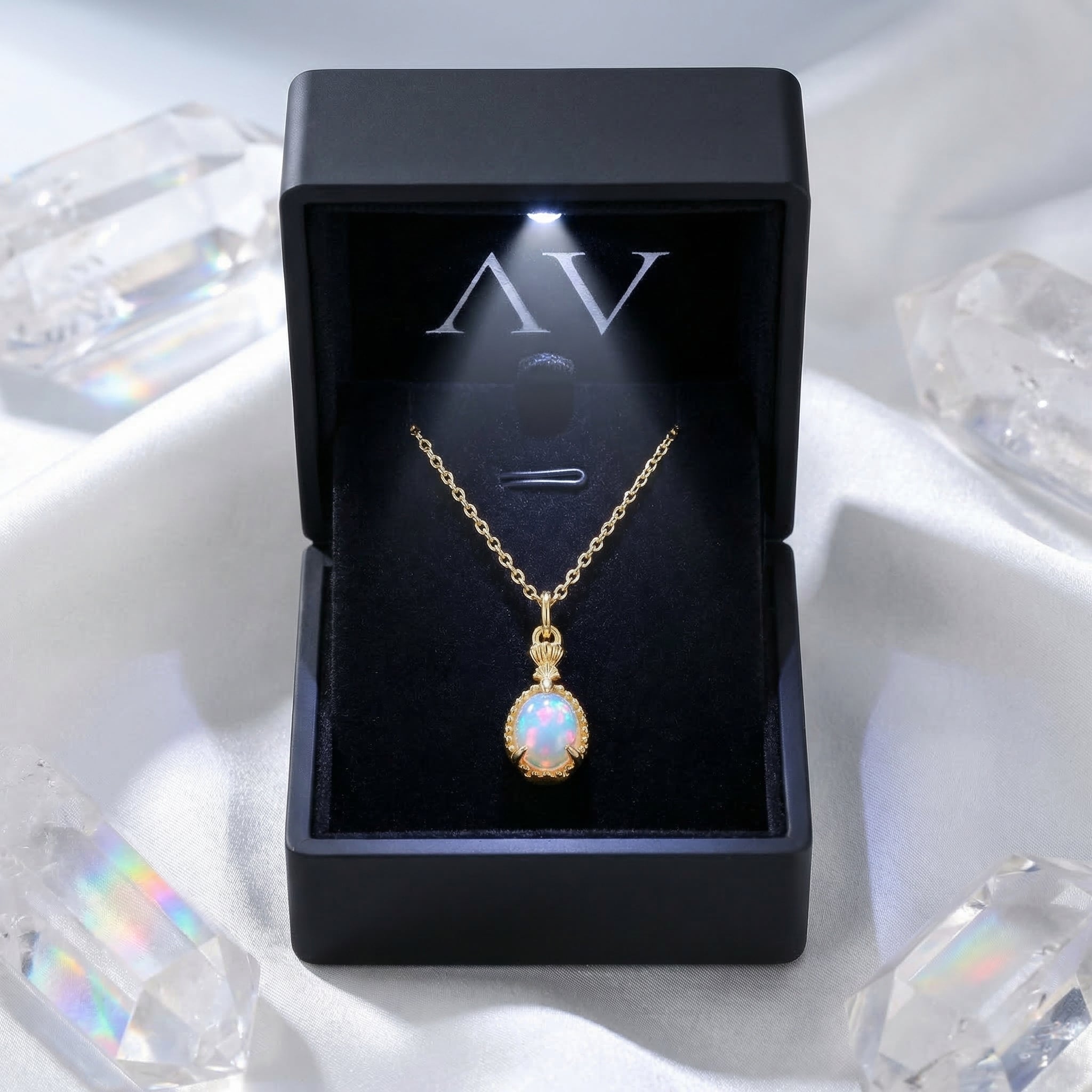 Gold-tone pear cut natural opal necklace displayed in a black LED-lit jewelry gift box with crystals.