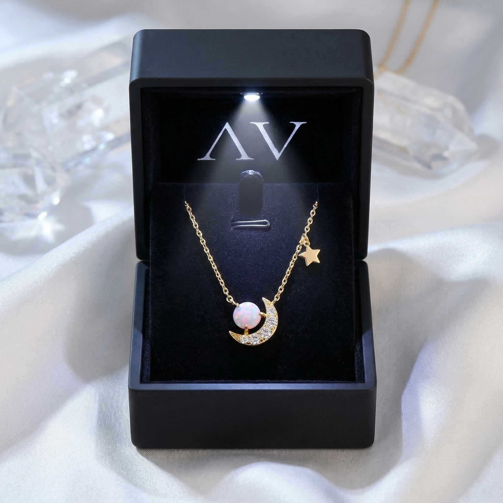 Gold Stellara opal necklace displayed in a premium black lighted gift box on white silk.