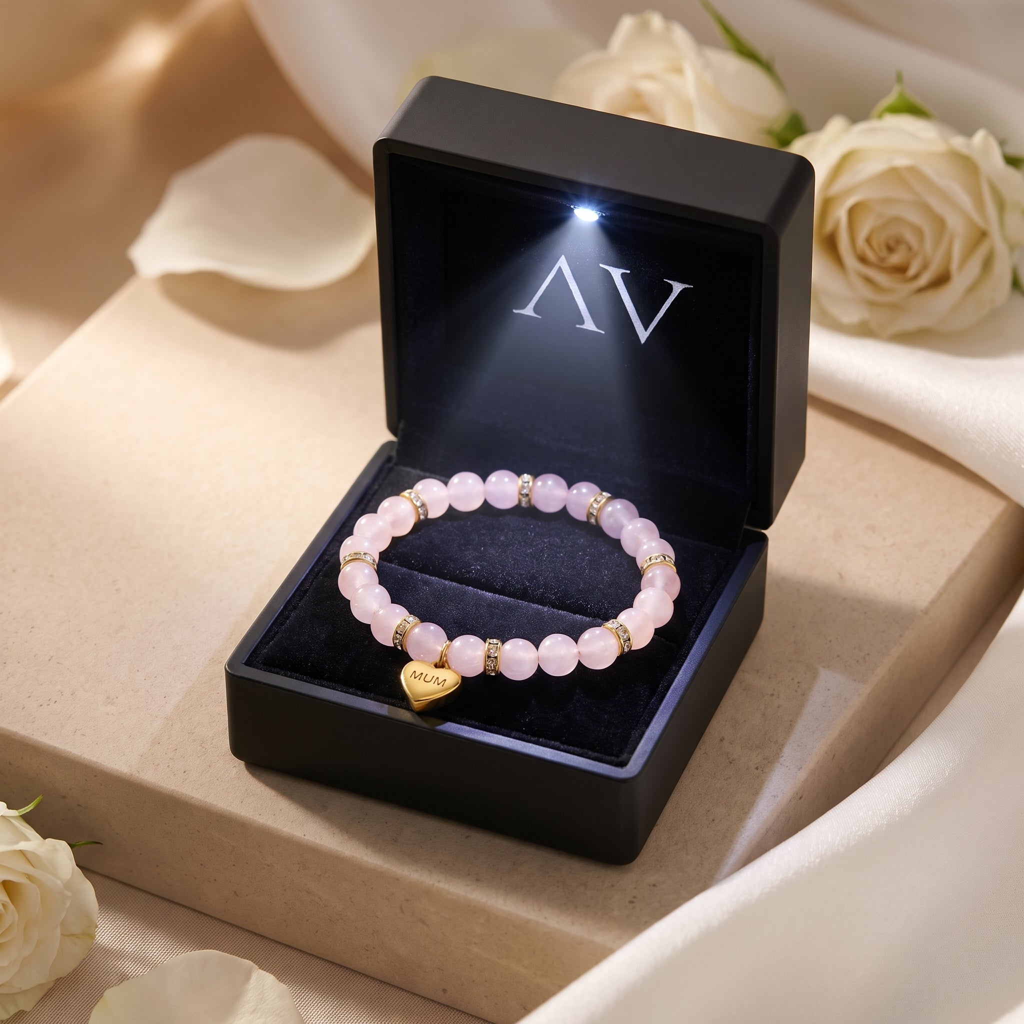 Rose quartz bracelet with gold MUM charm in a black LED-lit presentation gift box.