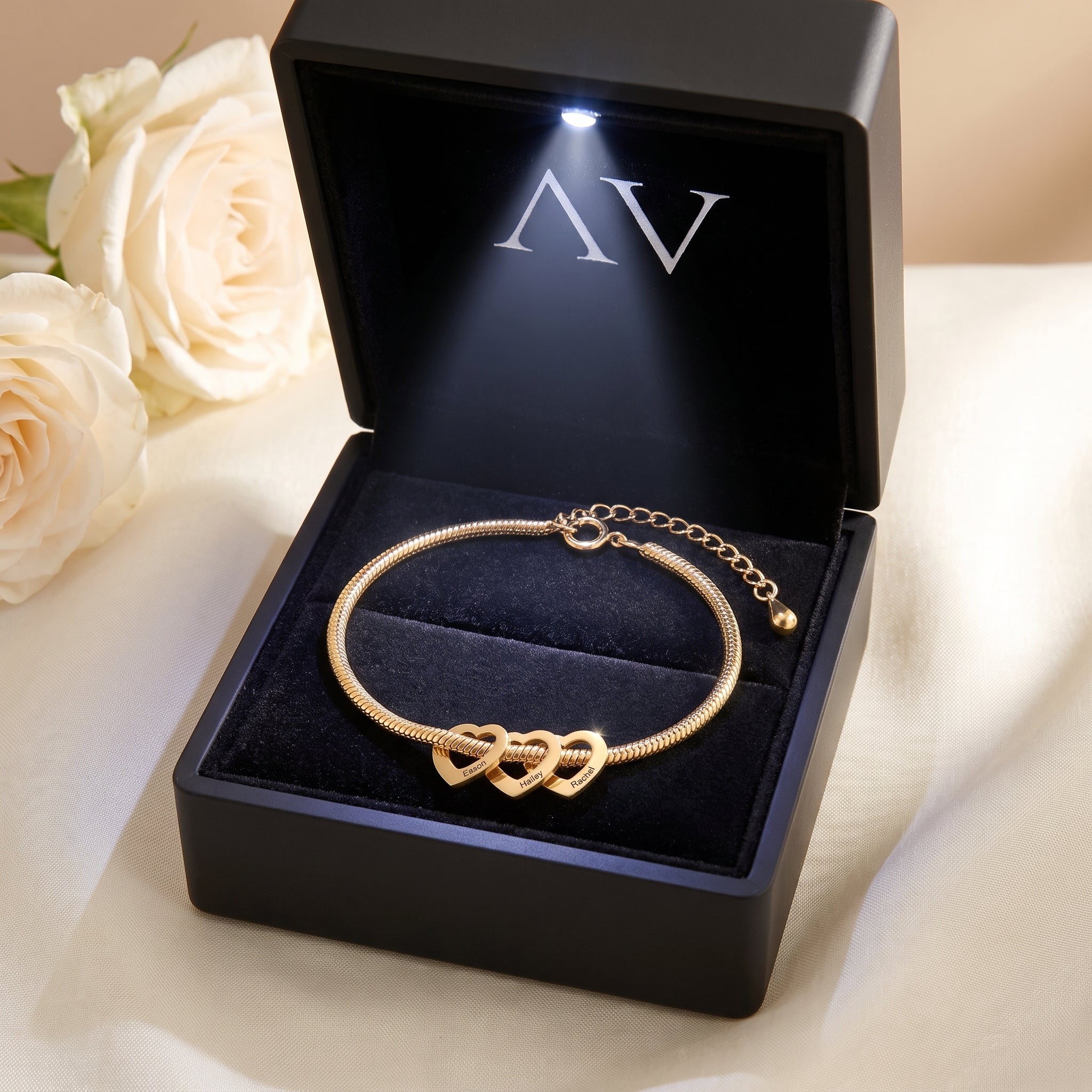 18K gold finish personalized heart charm bracelet inside a black LED-lit jewelry gift box.