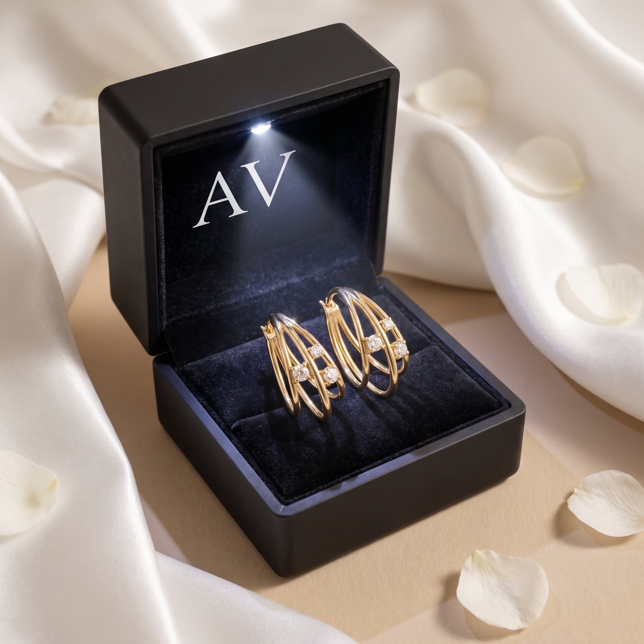 Gold moissanite hoop earrings inside a black LED-lit jewelry gift box.