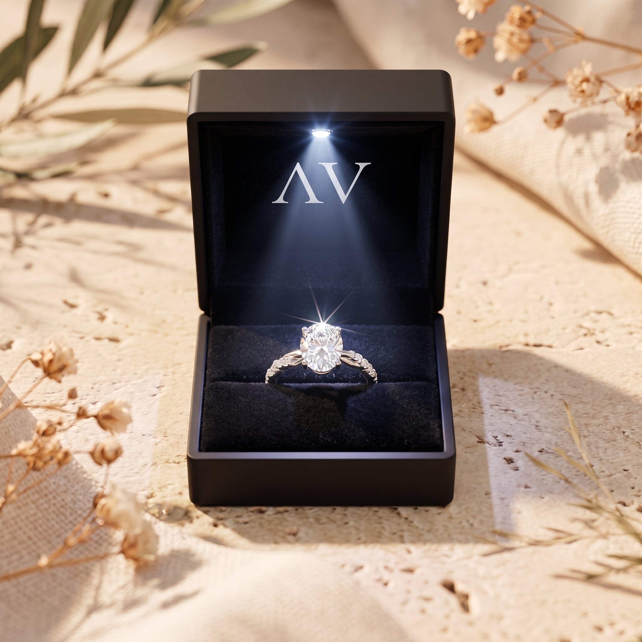 Oval moissanite ring in lit black gift box.