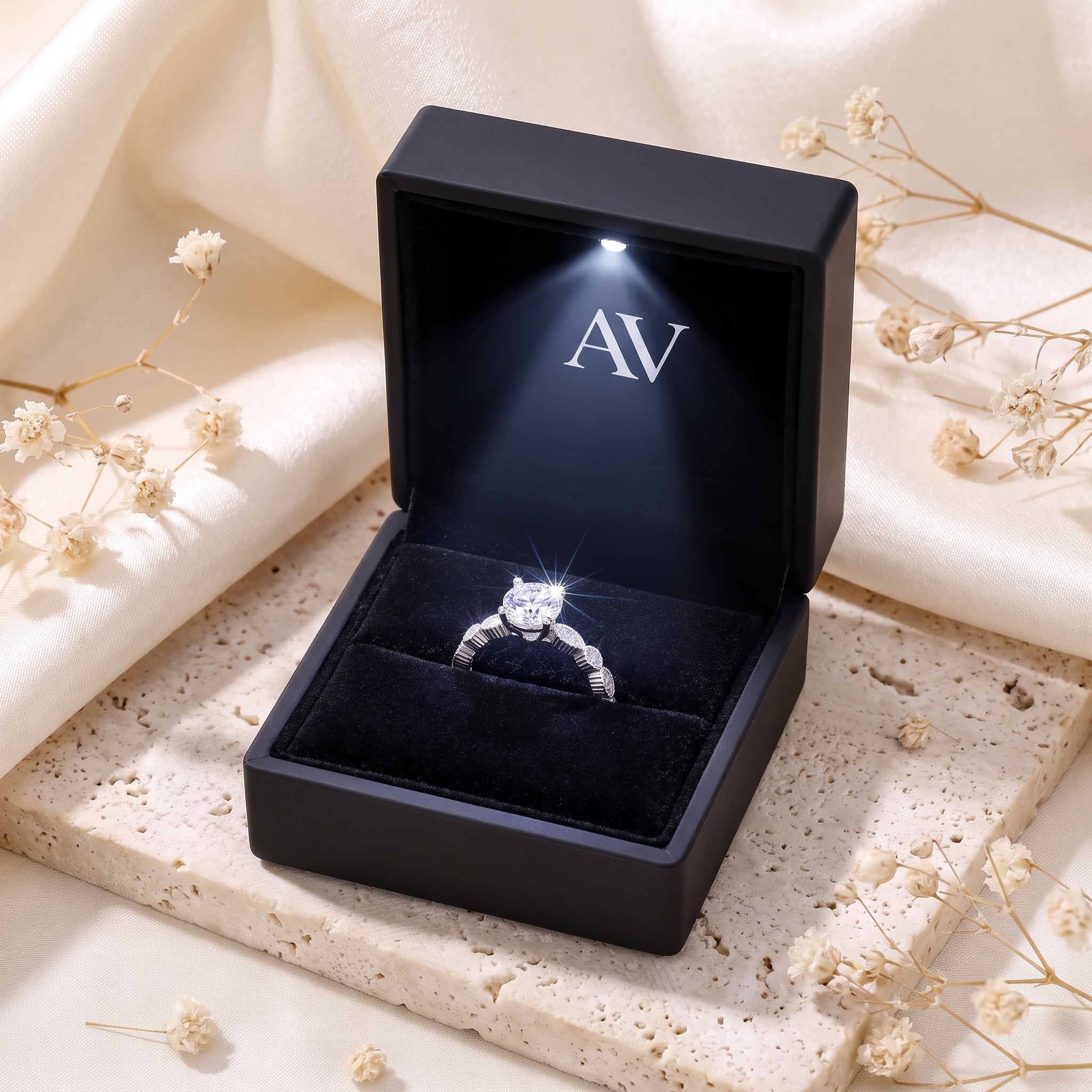 Silver round cubic zirconia solitaire ring inside a black LED-lit branded jewelry presentation box.