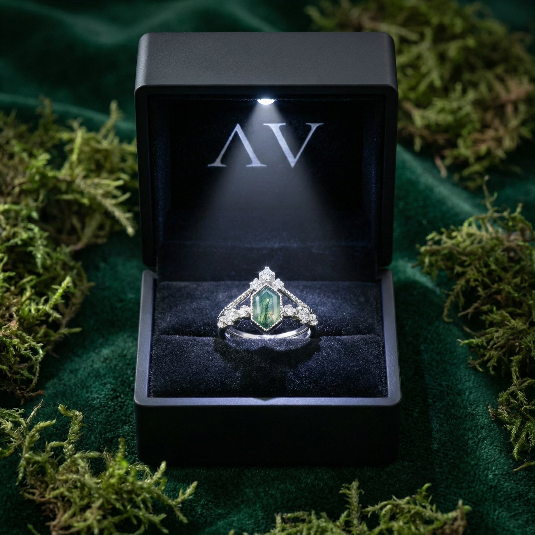 Sterling silver kite cut moss agate and diamond ring duo in a lighted black gift box on moss.