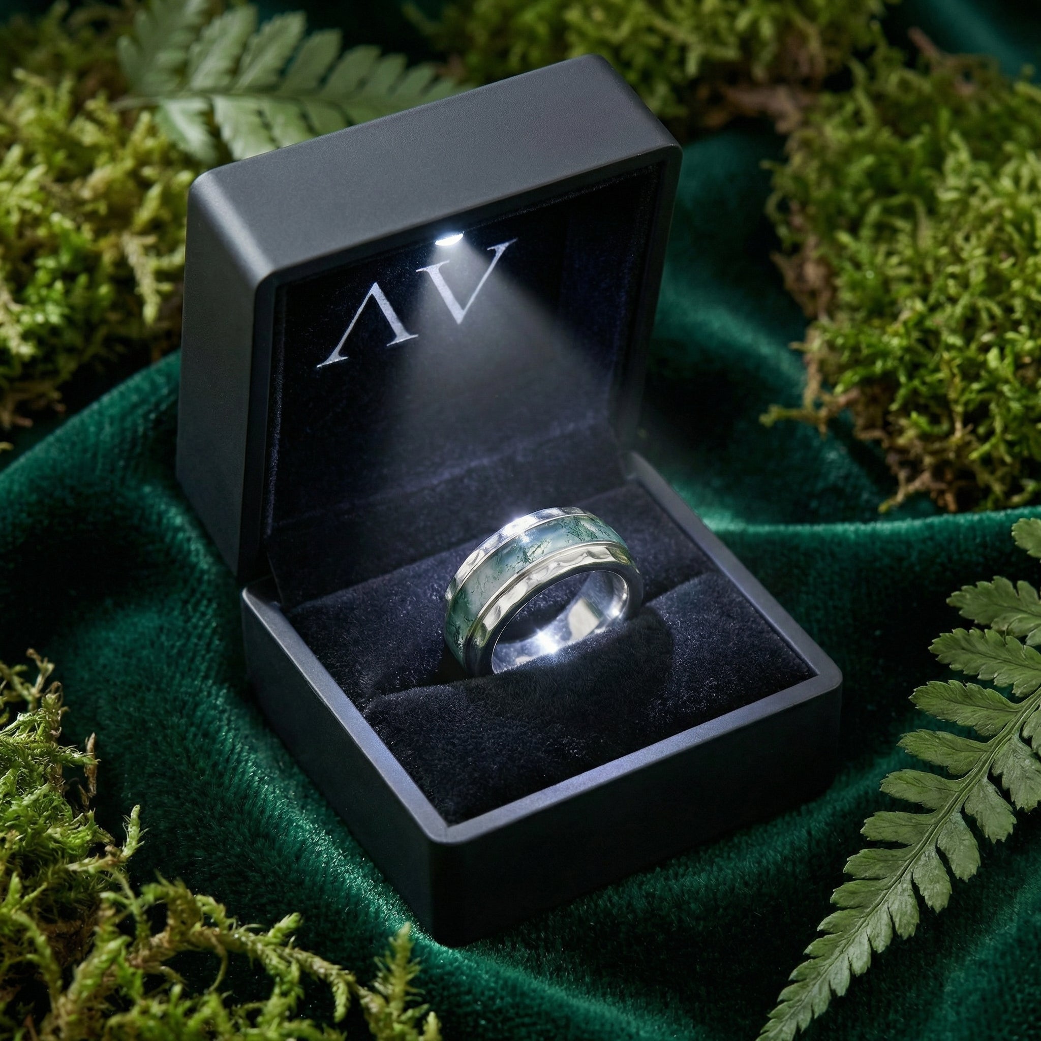 Natural moss agate sterling silver inlay ring inside a black LED-lit gift box on a bed of moss.