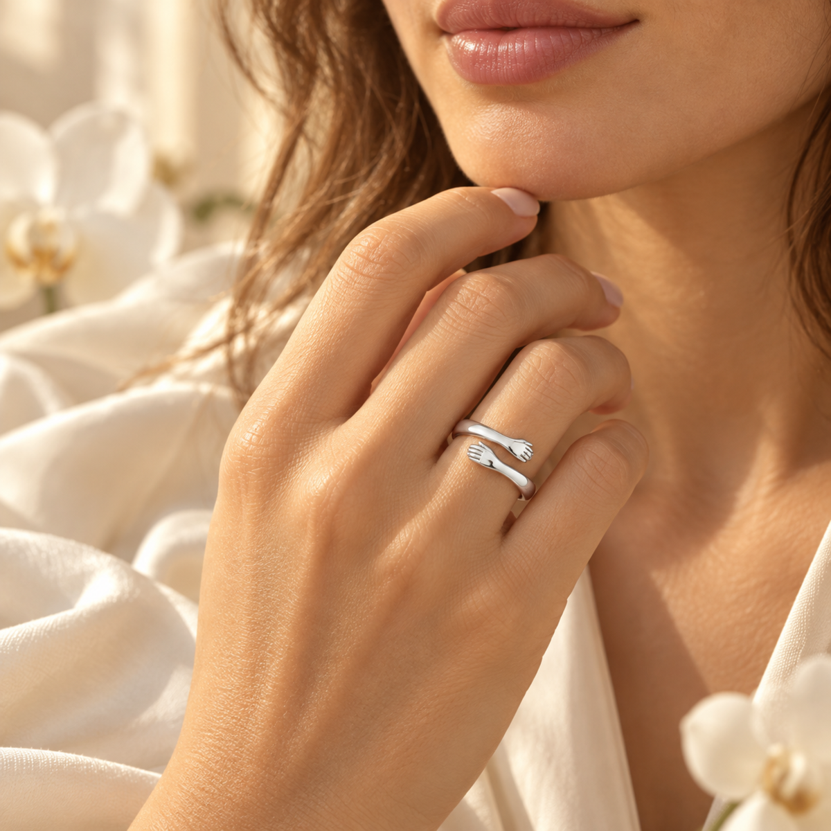 Silver hug ring worn on a hand