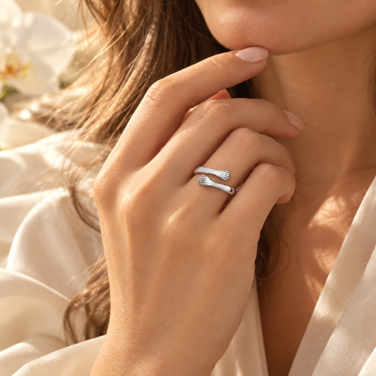 Silver open hug ring worn on a hand