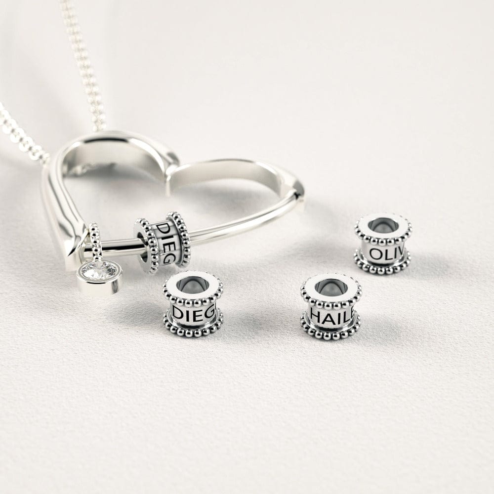 Herzkette mit gravierten Perlen und Diamant