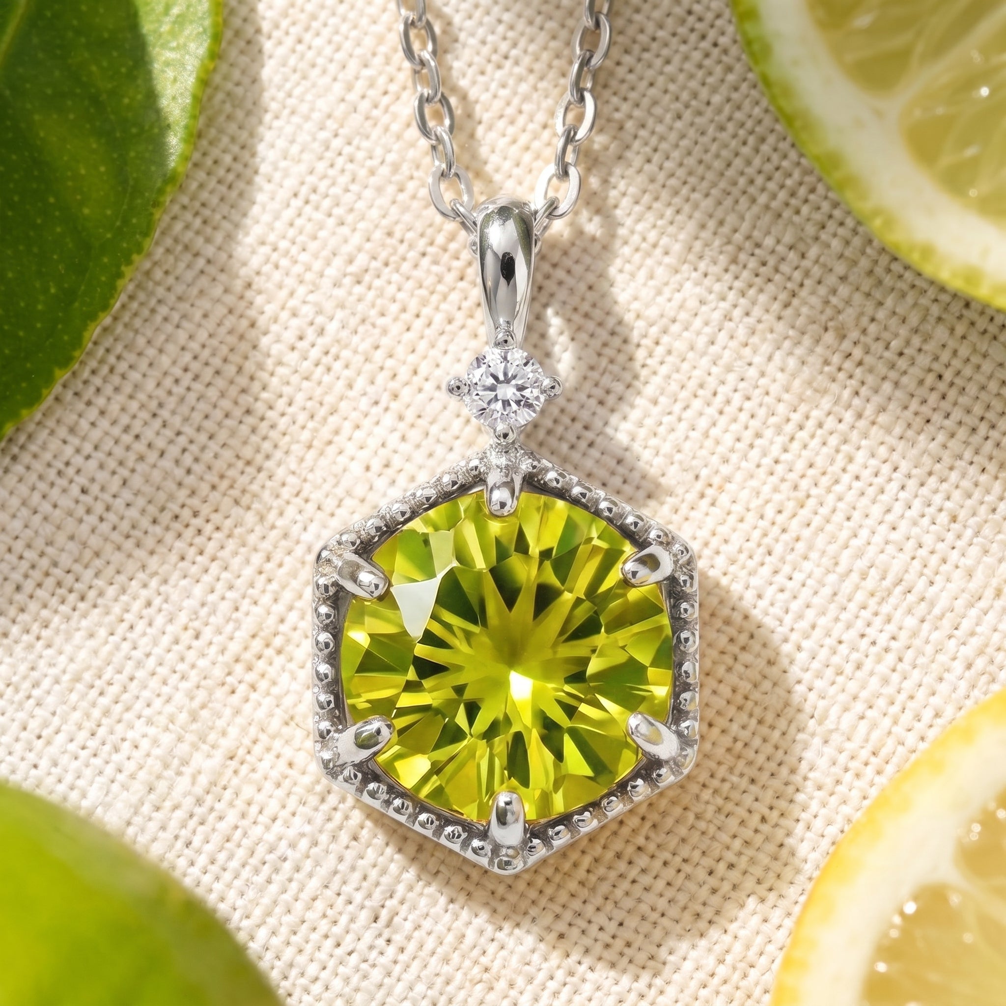 The Belenis Hex necklace in solid white gold with a hexagonal simulated peridot.