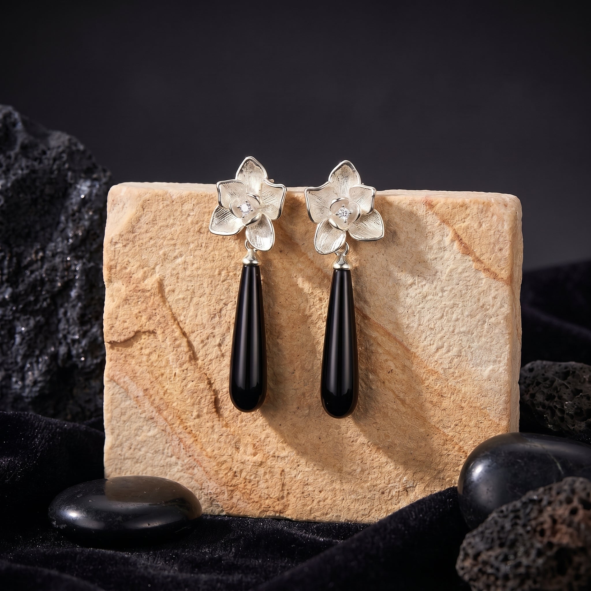 Calla onyx drop earrings showcasing the floral motif and elongated stone.