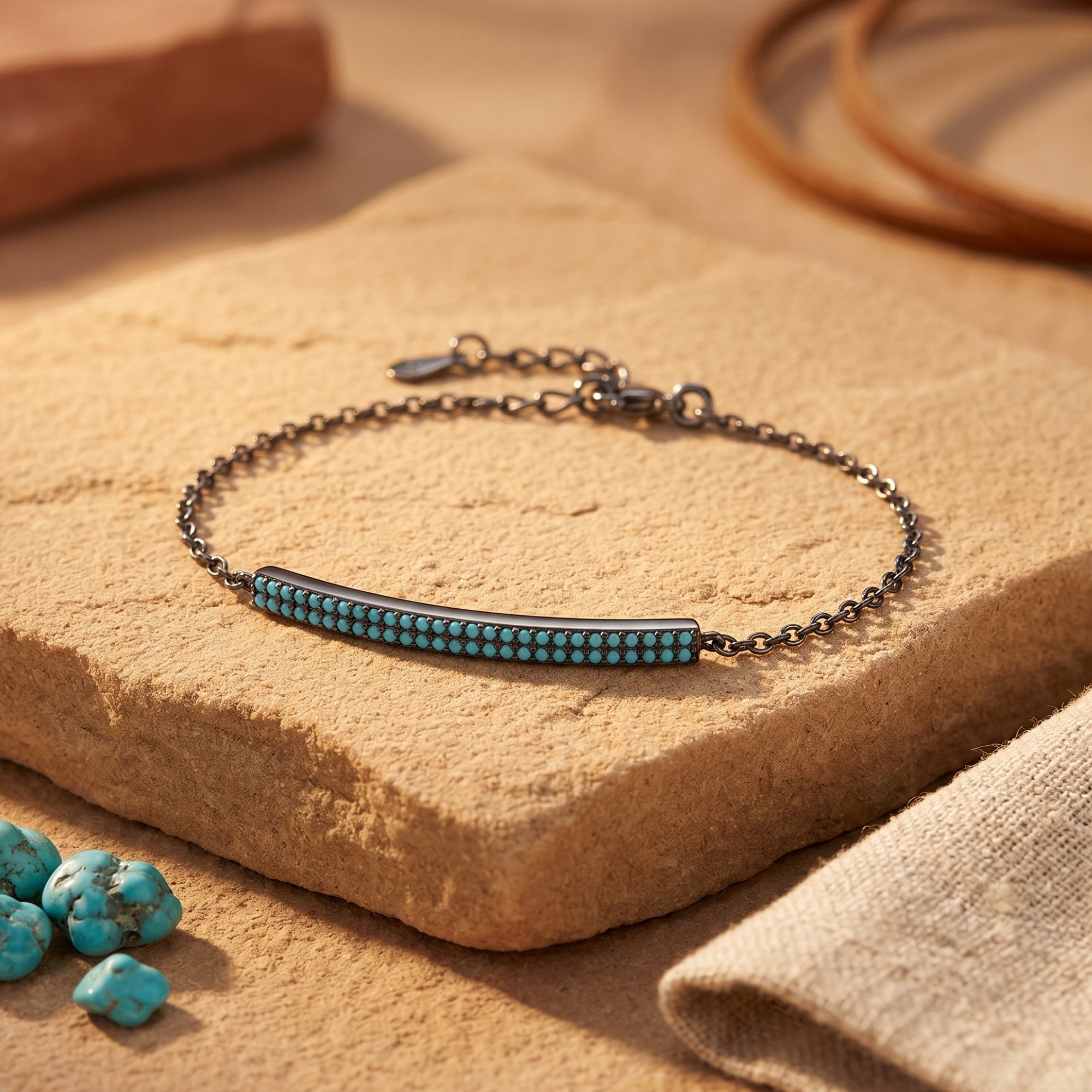 Sterling silver Escalante bracelet with a turquoise-set bar resting on a natural stone in a Southwestern setting.