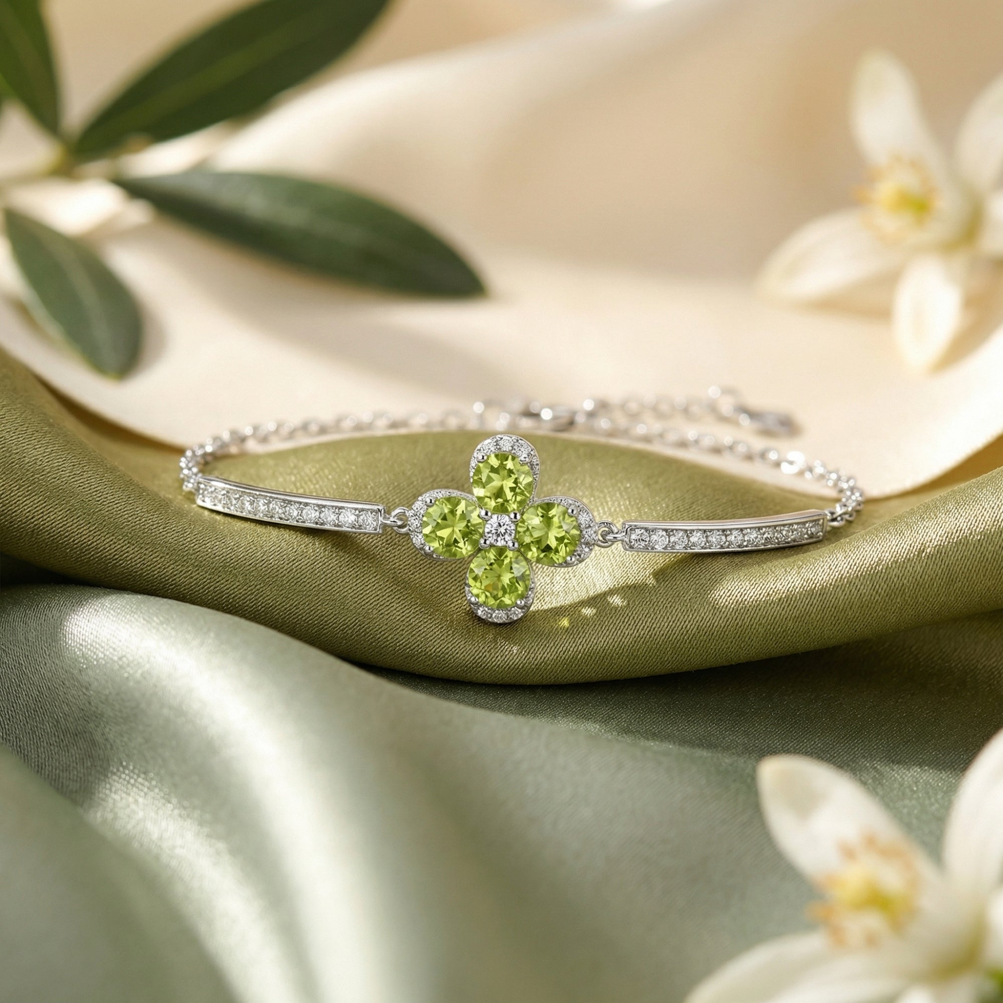 S925 sterling silver station bracelet with round cut natural peridot clover center on green silk fabric.