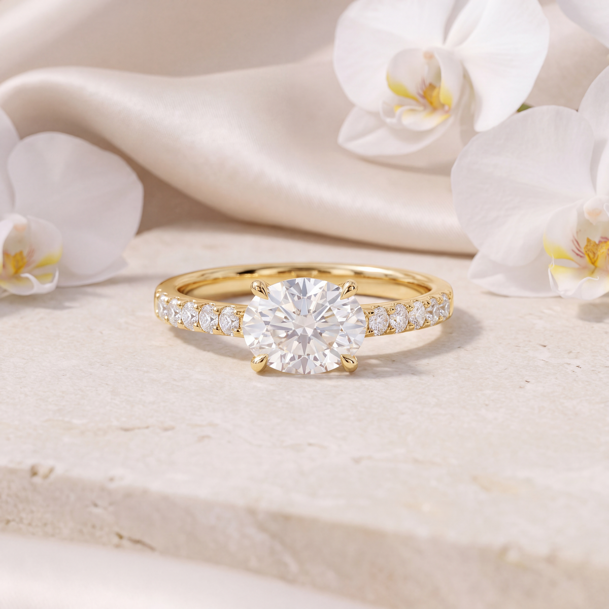 Front view of a gold moissanite engagement ring with a round center stone and pave band.