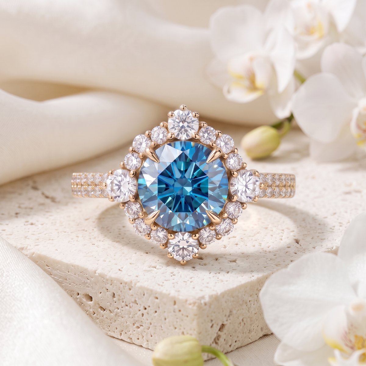 A yellow gold halo ring featuring a brilliant round blue moissanite center stone surrounded by a diamond cluster halo.