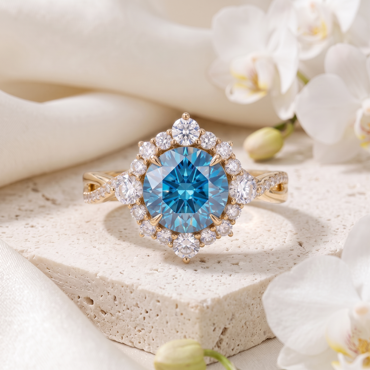 Front view of a yellow gold halo ring featuring a brilliant blue round moissanite center stone on a stone pedestal.