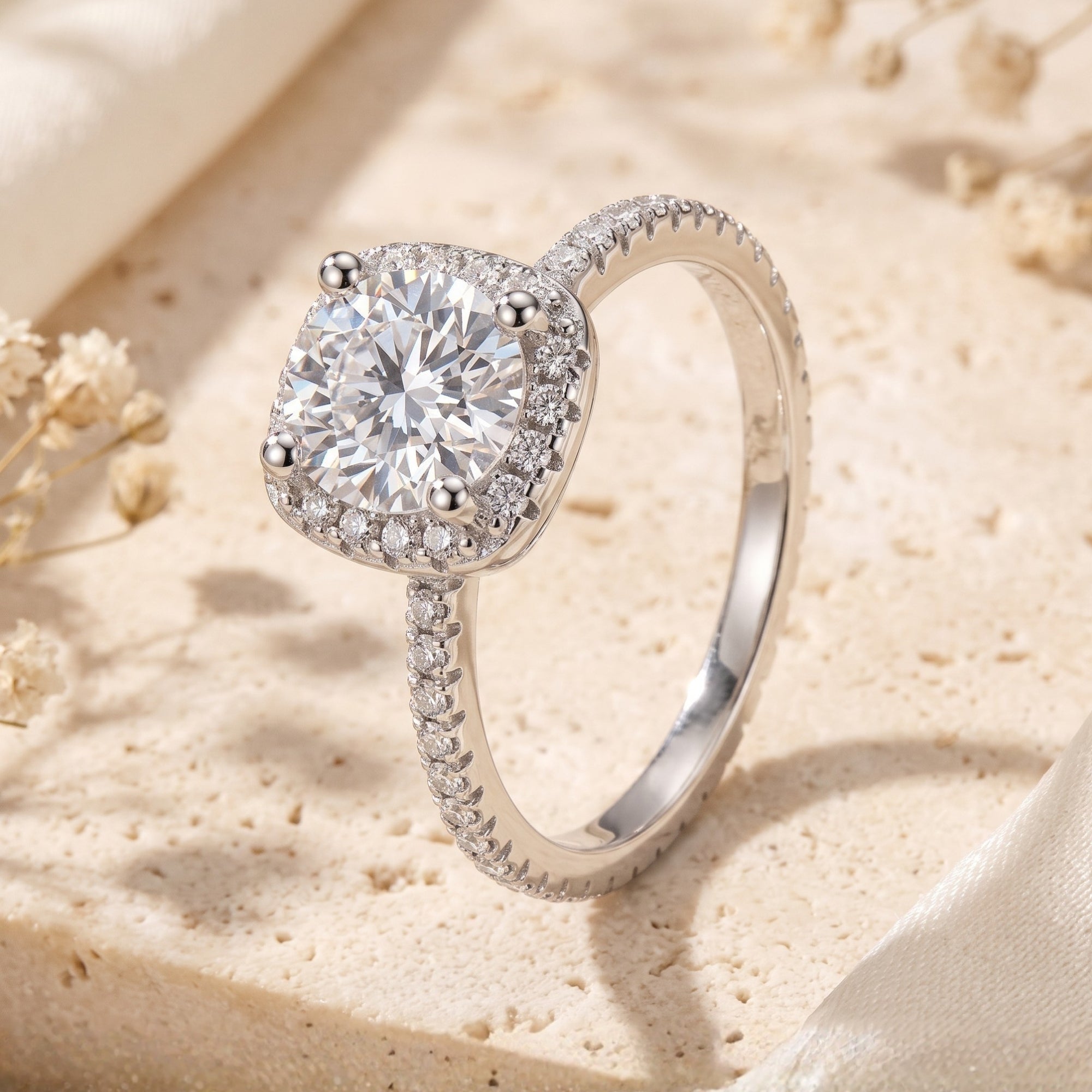 Cushion halo promise ring in S925 sterling silver with cubic zirconia on a stone surface.