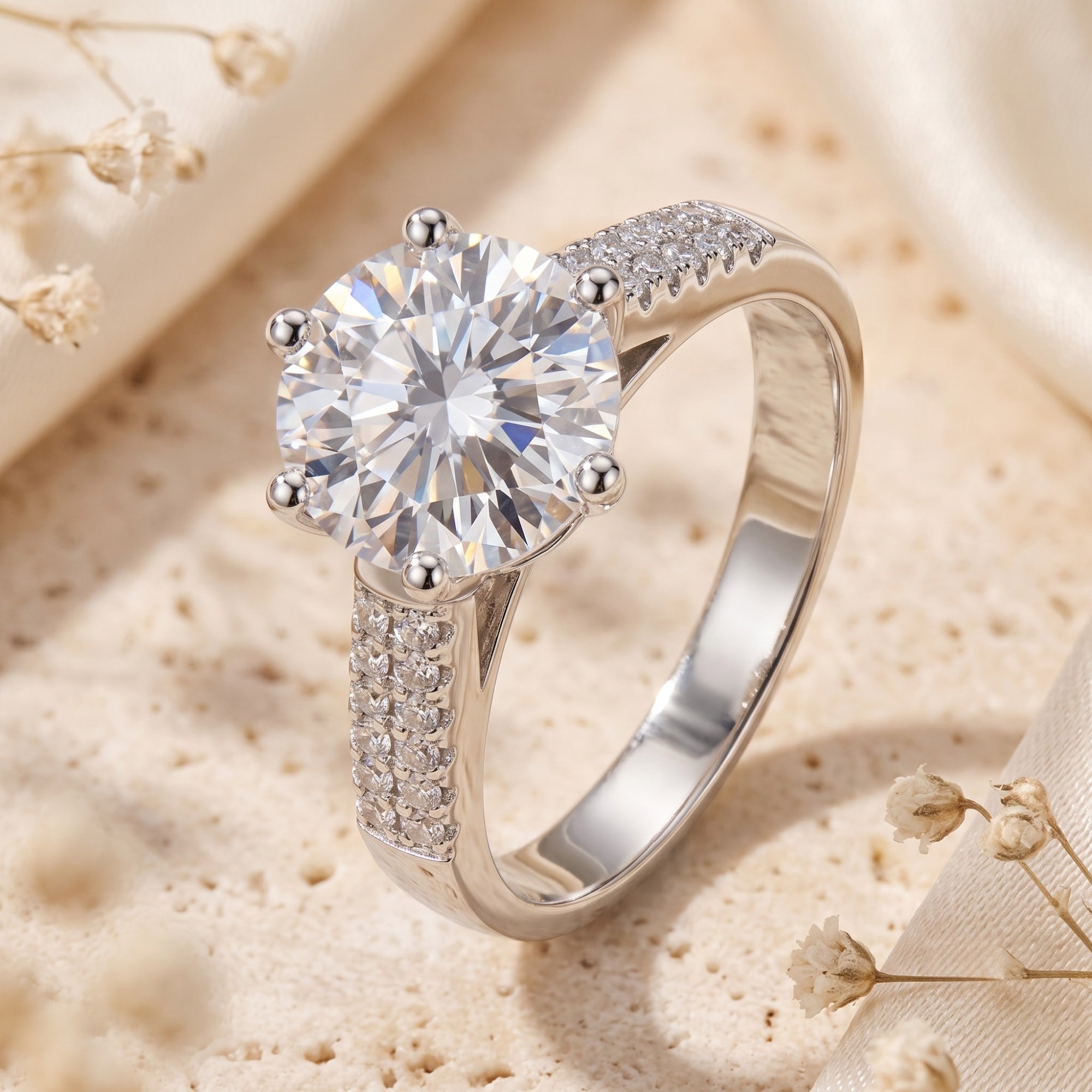 Round-cut simulated diamond sterling silver ring on textured stone background.