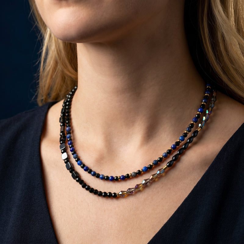 Model wearing the Azure Constellation layered necklace with blue lapis lazuli and black faceted beads.