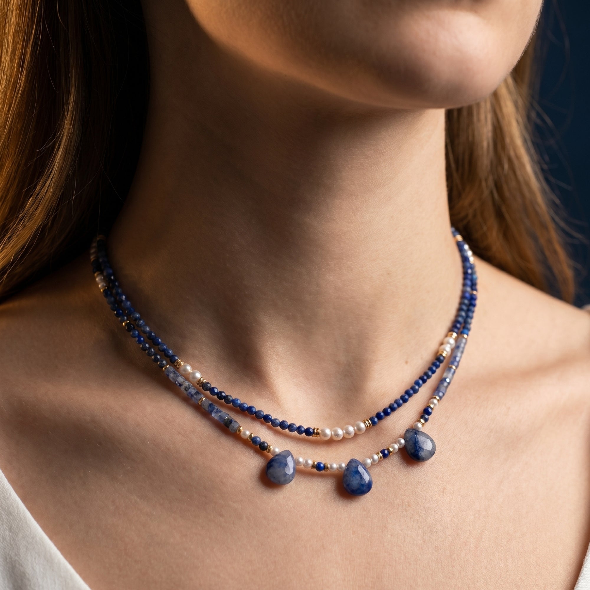 Model wearing the Celestial Harmony layered lapis and pearl necklace set in 18k gold plated copper.