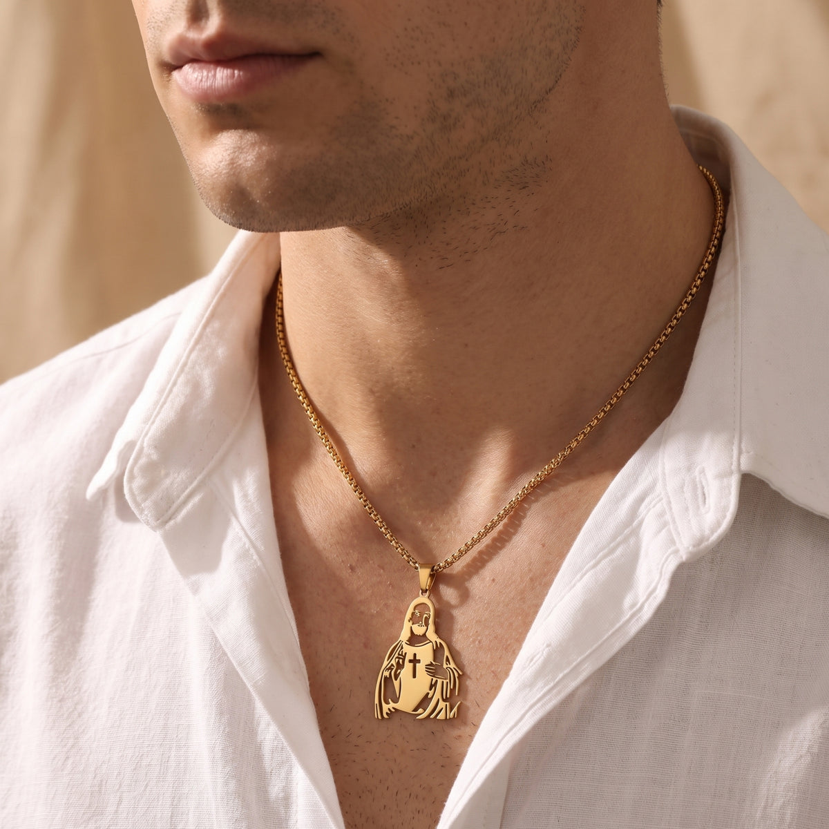 Man wearing a gold-tone Christ silhouette pendant with a cross cutout over an open white shirt.