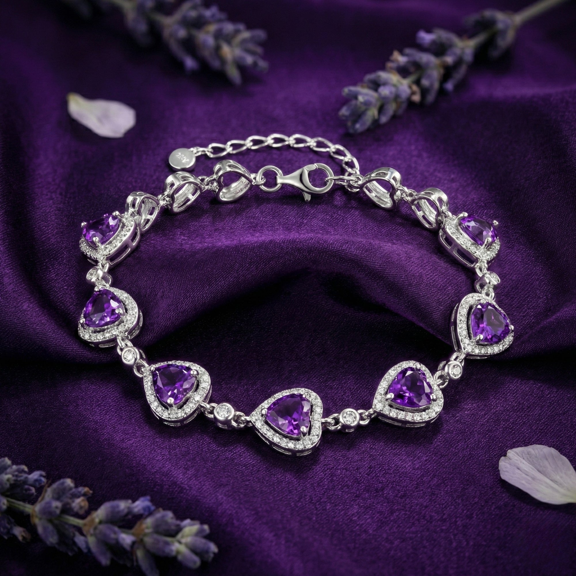 Liliana sterling silver bracelet featuring seven heart-cut amethysts displayed on purple satin fabric.