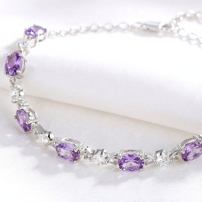 Macro view of the Valeriane sterling silver bracelet showing oval-cut simulated amethyst and round clear stones.