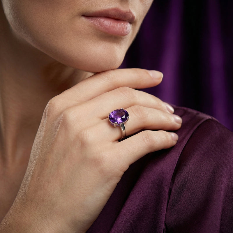 Woman wearing the large oval amethyst statement ring in sterling silver on her finger.