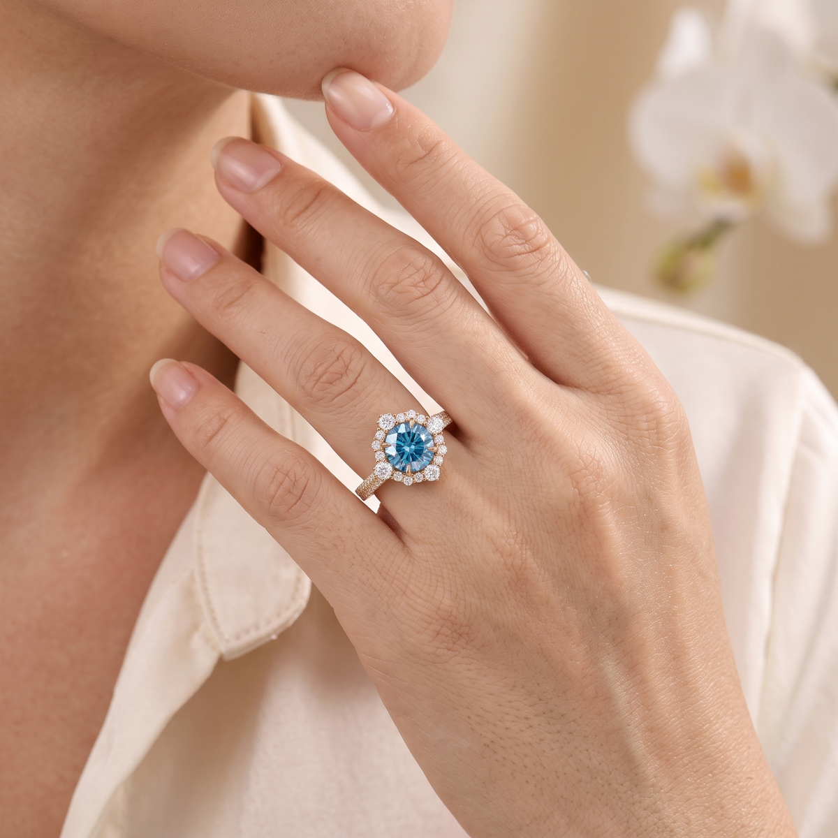 A model wearing a rose gold blue moissanite cluster halo ring on her hand.